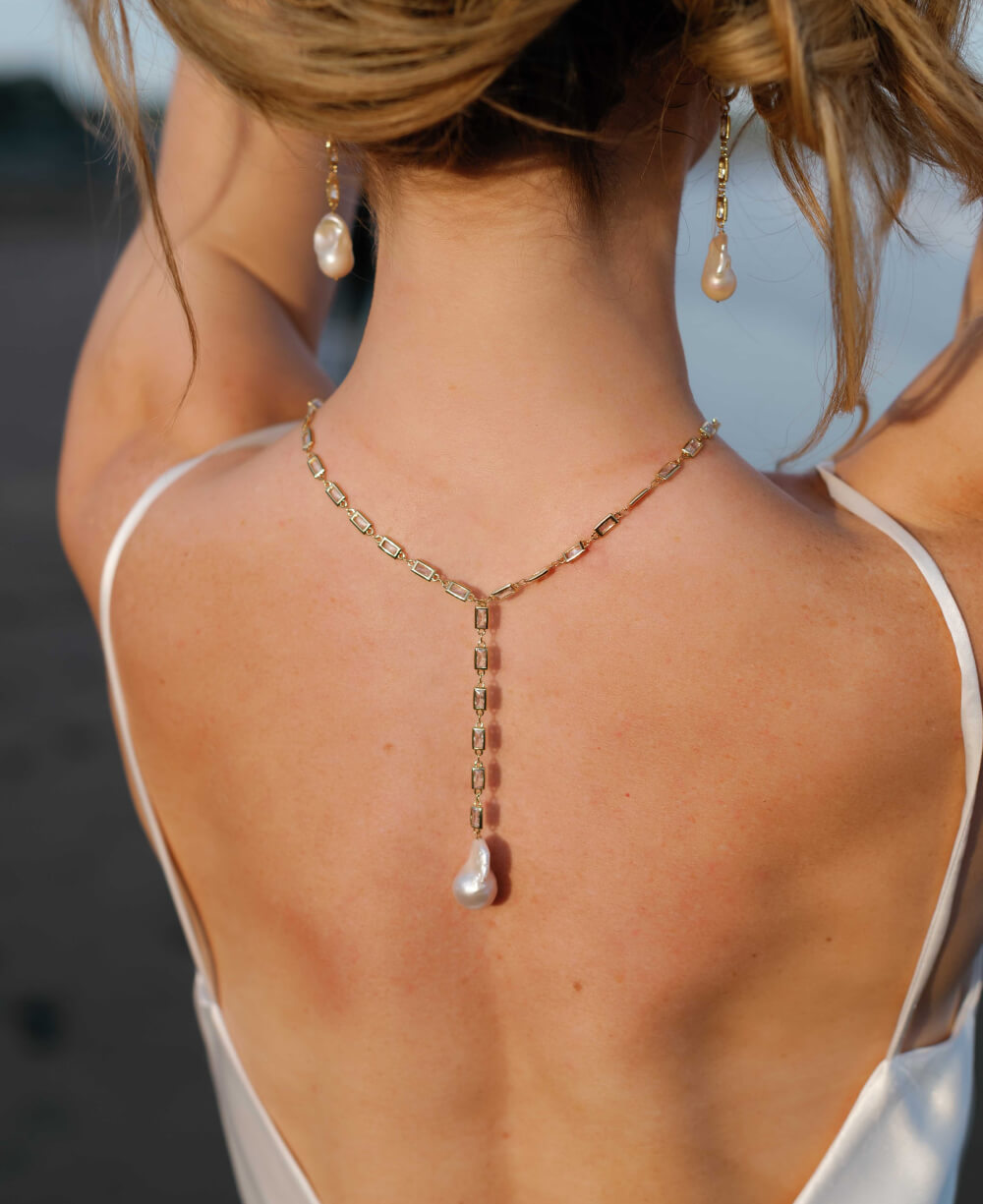 A freshwater pearl bridal necklace and earring set shown from the back.