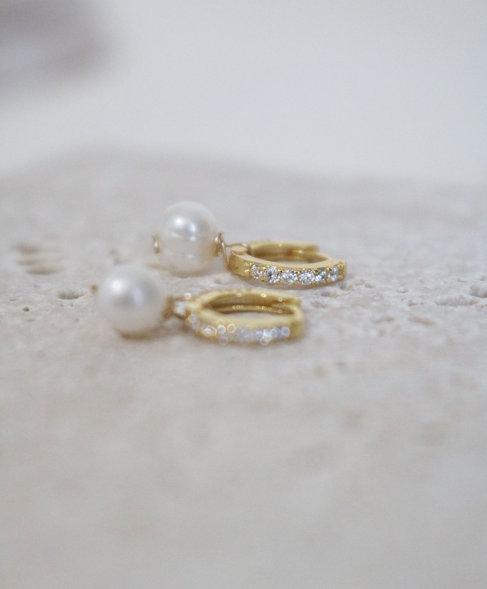 A pair of Modern Crystal Pearl Drop Bridal Huggies in Gold-filled. Canadian jewelry designs. Bridal jewelry Canada. Pearl jewelry Canada. Pearl Bridal jewelry Canada. Gold-filled jewelry Canada. Organic pearl jewelry. Canadian bridal jewelry.
