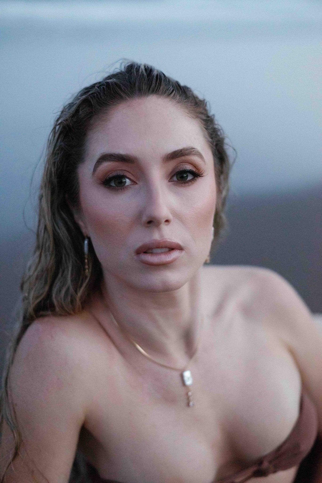 A sultry goddess holds the camera's gaze; adorned with the Nerida Gold-filled crystal and freshwater pearl necklace with matching earrings. Handmade jewelry Canada. Pearl jewelry Canada. Pearl Bridal jewelry Canada. Gold-filled jewelry Canada. Gold-filled Canadian jewelry. Bridal jewelry Canada. Organic pearl jewelry. Pearl jewelry sets.