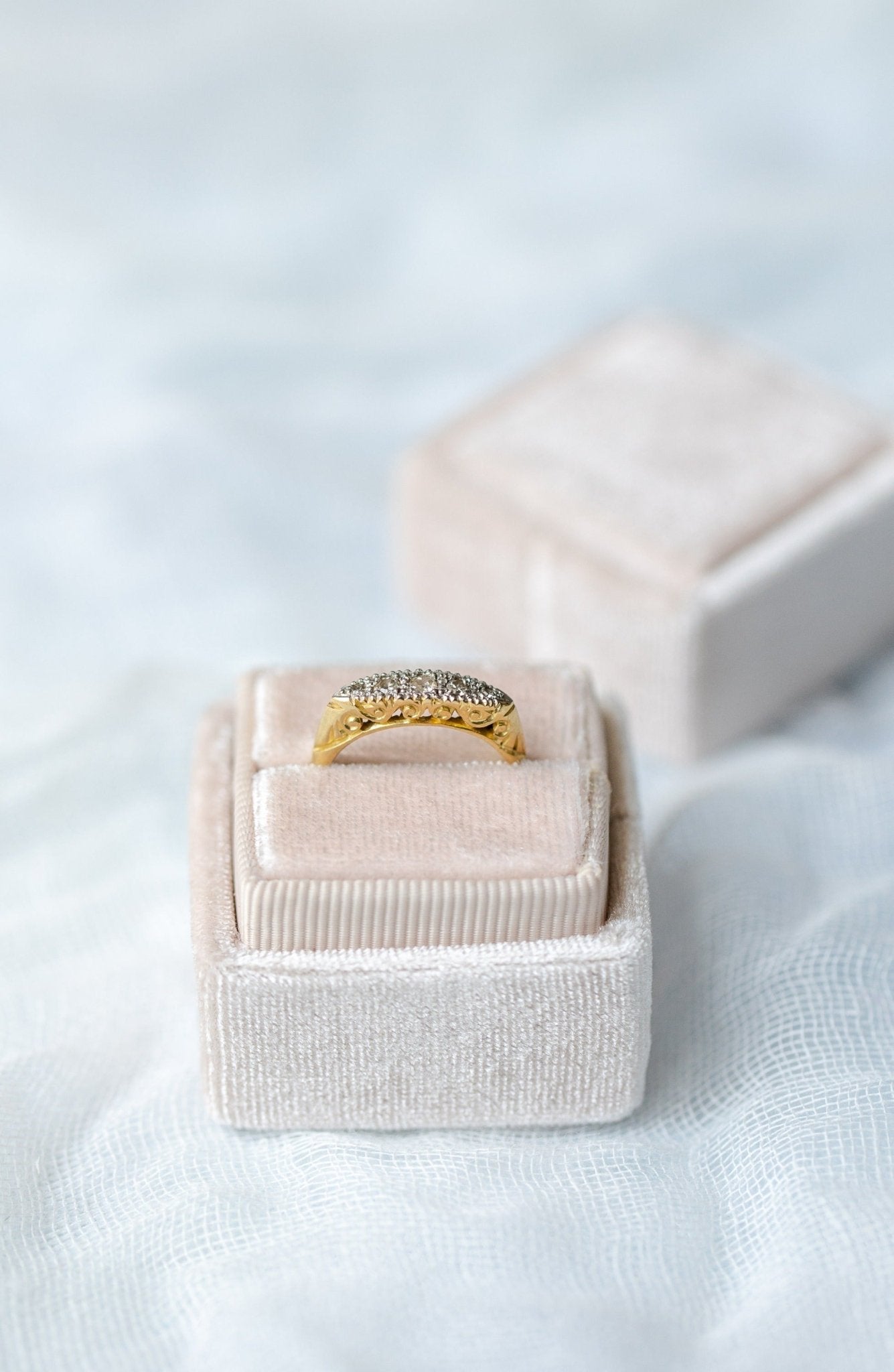 Front side view of the Odette Art Nouveau 1900s Platinum and 18K Yellow Gold Diamond Vintage Engagement Ring in square beige ring box. Antique Engagement Rings Canada. Canadian vintage engagement rings. Vintage engagement rings Canada. Bridal jewelry Canada. Canadian weddings. Wedding Canada. Canadian bridal jewelry. Woman-owned Canadian jewelry brand. Canadian jewelry business.