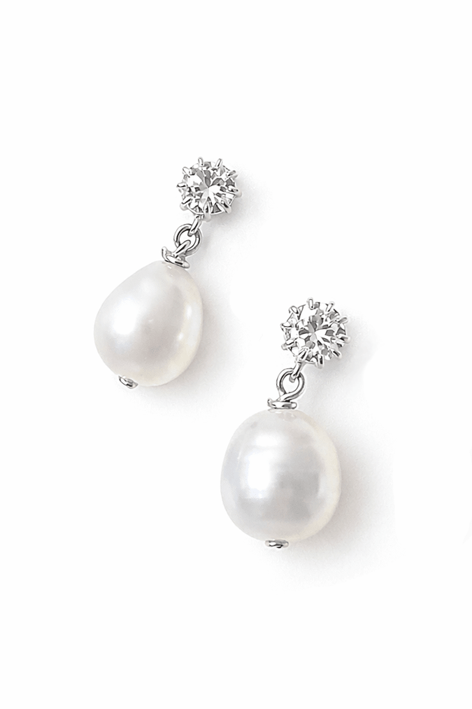 A pair of freshwater pearl earrings with crystal studs on a white background. Sterling silver jewelry, bridesmaids earrings, & bridesmaid jewelry handmade by Canadian BIPOC jewelry designer