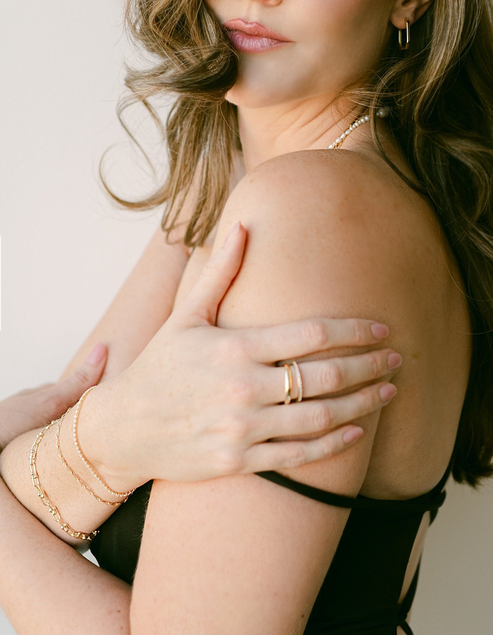 Woman with gold-filled bracelet stack and gold rings. Everyday jewelry Canada. Handmade jewelry Canada.