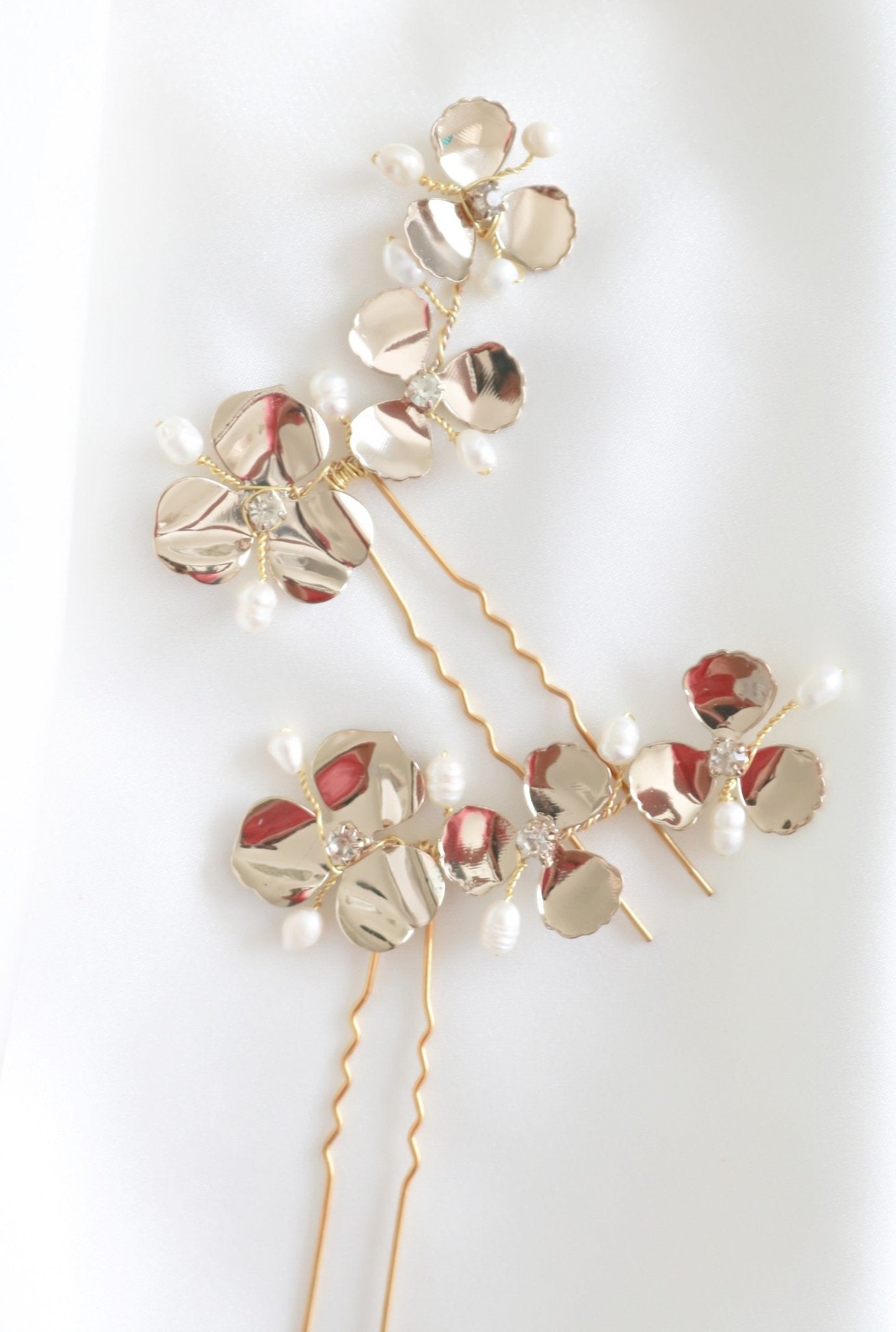 Several Posey Flower Bridal Hairpin with Fresh Water Pearls in Gold. Bridal Hair Accessories and pearl bridal accessories handmade in Canada by woman-owned jewelry business.