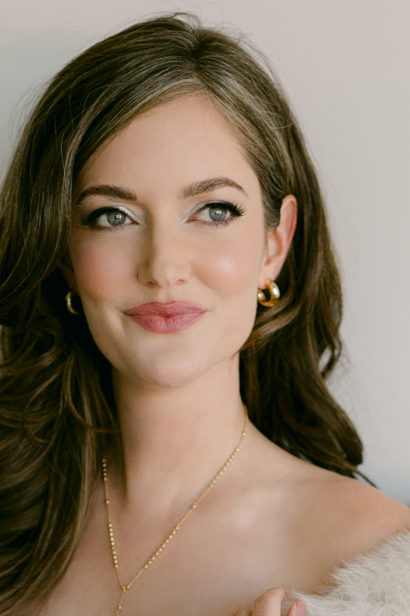Woman wearing puffy gold-filled hoop earrings and gold beaded necklace. Everyday jewelry Canada. Gold-filled jewelry.
