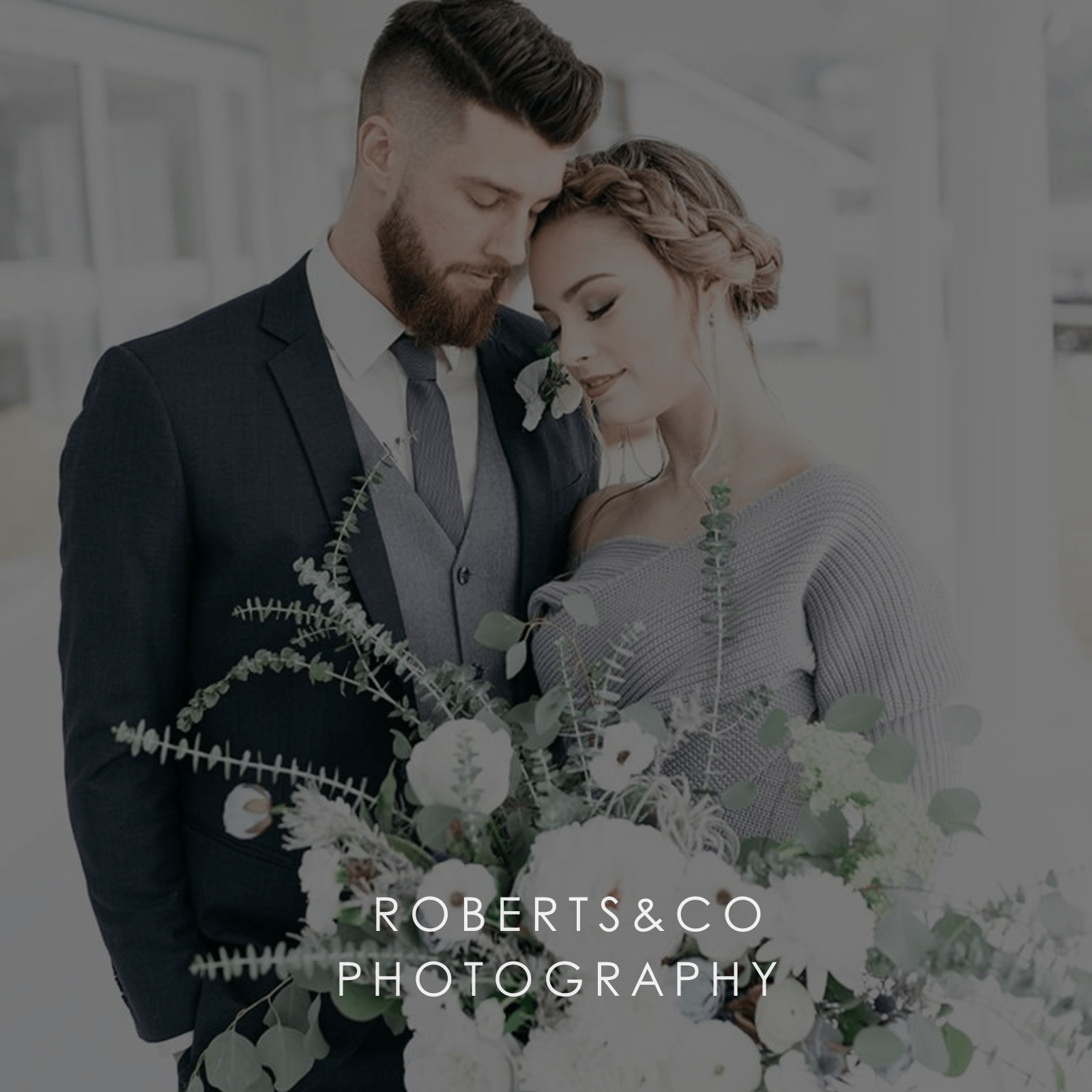 A more casual wedding couple share an intimate moment with white bridal flower bouquet.