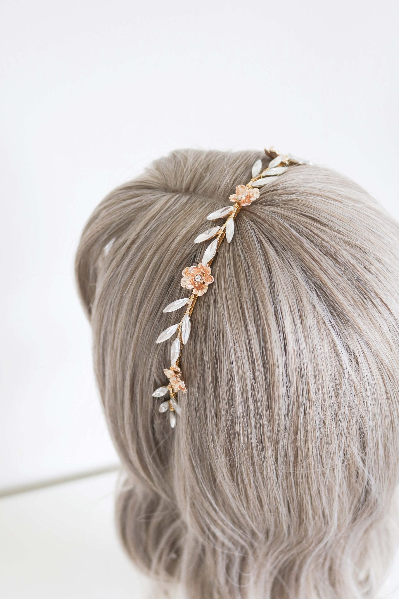 The Gold Rosalie Crystal Leaf and Gold Rose Headband on a head bust wig. Bridal Hair Accessories. Bridal Accessories. Canadian Bridal Accessories. Handmade Canadian Accessories. Canadian handmade Accessories. Organic pearl accessories. Canadian weddings. Wedding Canada.