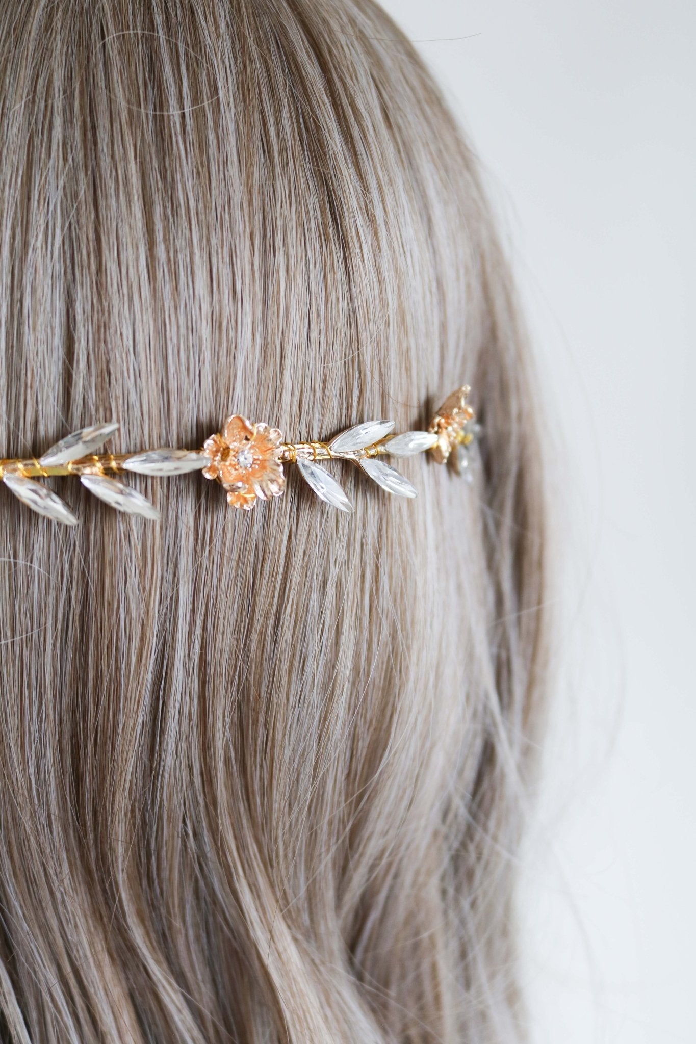 A close up of the Rosalie Crystal Leaf and Gold Rose Bridal Headband on a head bust with wig. Bridal Hair Accessories. Bridal Accessories. Canadian Bridal Accessories. Handmade Canadian Accessories. Canadian handmade Accessories. Organic pearl accessories. Canadian weddings. Wedding Canada.