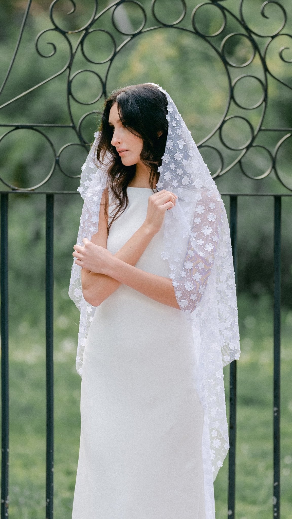A bride looking conservative as she pulls her Sonnet floral wedding veil close. Canadian weddings. Wedding Canada. Wedding veils Canada. Bridal Hair Accessories. Bridal Accessories. Canadian Bridal Accessories. Handmade Canadian Accessories. Canadian handmade Accessories. Canadian designer. Canadian artist.