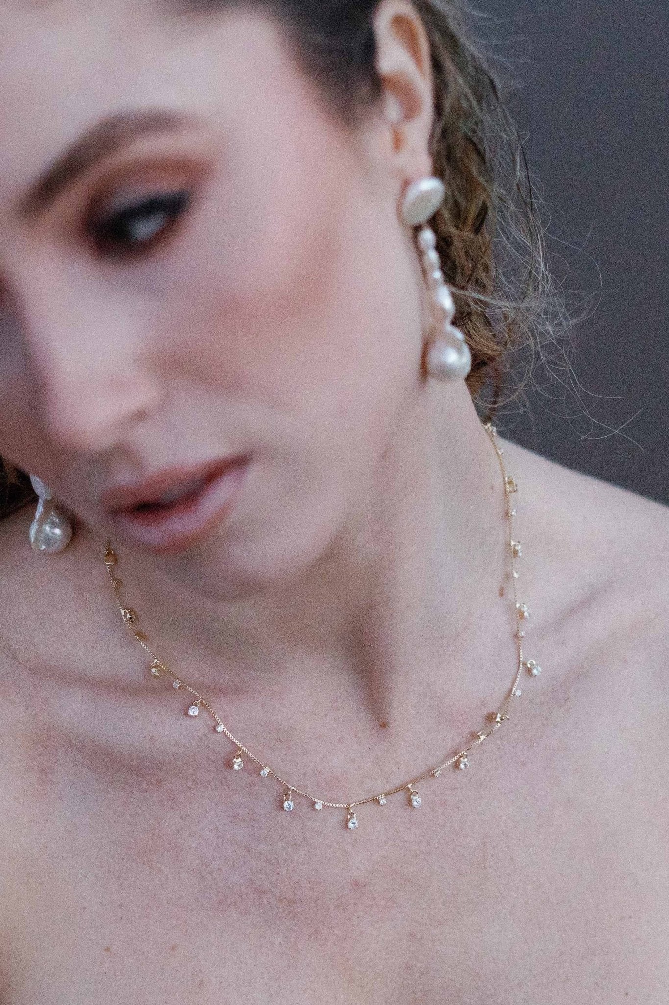 A beachy bride showcases the Stardust crystal necklace with dangle freshwater pearl earrings. Gold-filled jewelry Canada. Canadian jewelry brands. Gold-filled Canadian jewelry. Affordable Canadian jewelry brands. Handmade Canadian jewelry. Canadian handmade jewelry. Small Canadian jewelry brands.