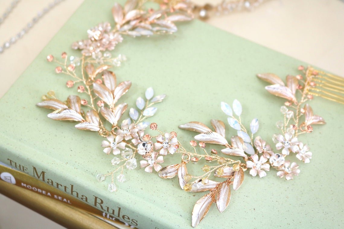 A Gold and crystal floral and leaf bridal hairvine sits on top of a stack of books. Bridal Hair Accessories. Bridal Accessories. Canadian Bridal Accessories. Handmade Canadian Accessories. Canadian handmade Accessories. Canadian weddings. Wedding Canada.
