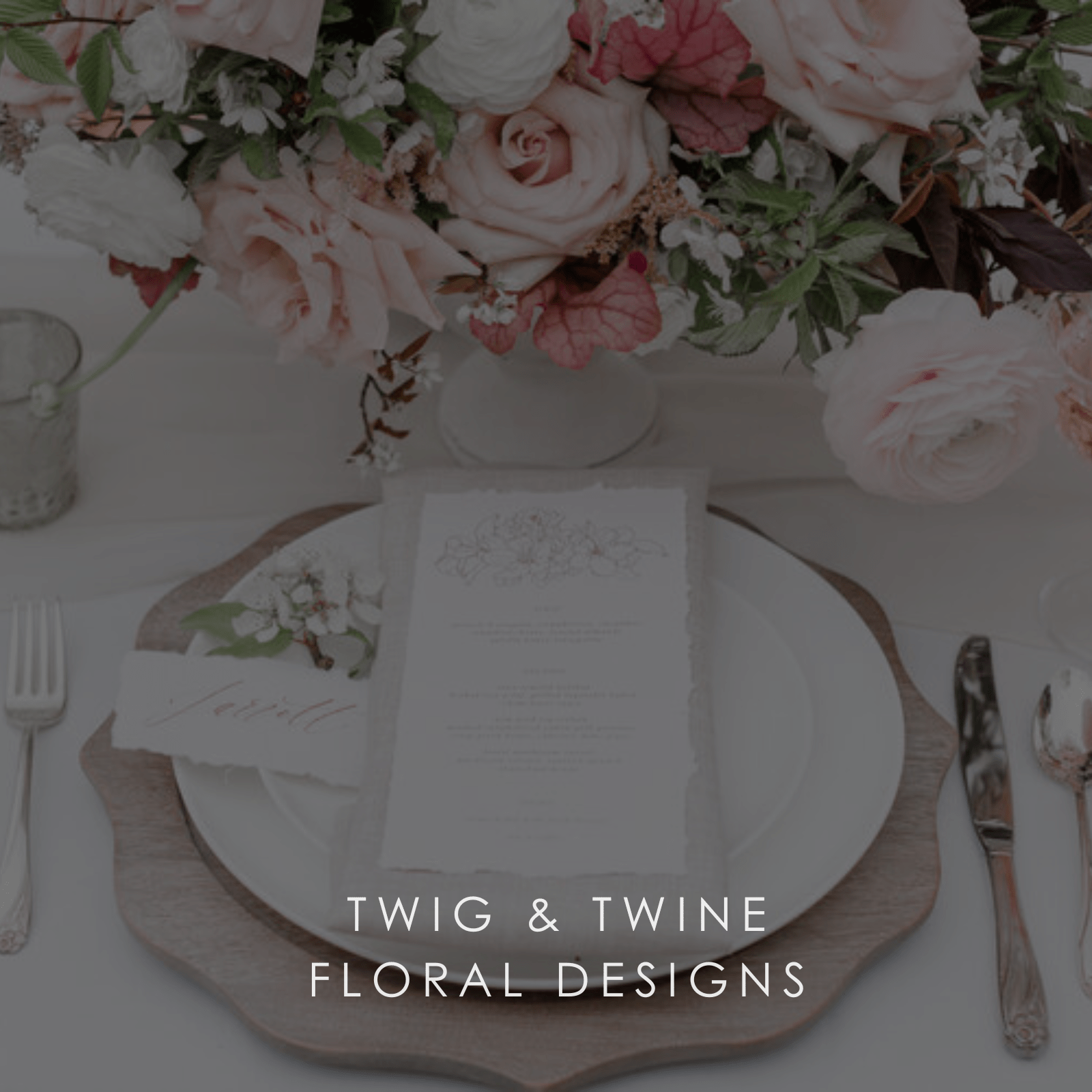 A piece of stationary on a plate for a wedding reception dinner with a bouquet of flowers in a photo for Twig & Twine Floral Designs.