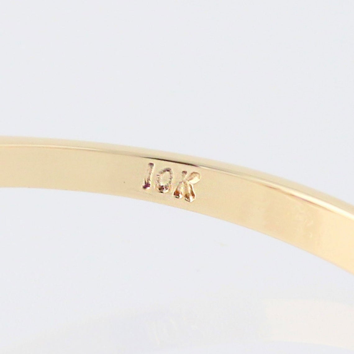Extreme close up of inside Viola vintage engagement ring 10k gold stamp. Antique Engagement Rings Canada. Canadian vintage engagement rings. Vintage engagement rings Canada. Bridal jewelry Canada. Canadian weddings. Wedding Canada. Canadian jewelry brands. Affordable Canadian jewelry brands. Canadian bridal jewelry. Woman-owned Canadian jewelry brand. Pearl jewelry Canada. Pearl Bridal jewelry Canada. Organic pearl jewelry.