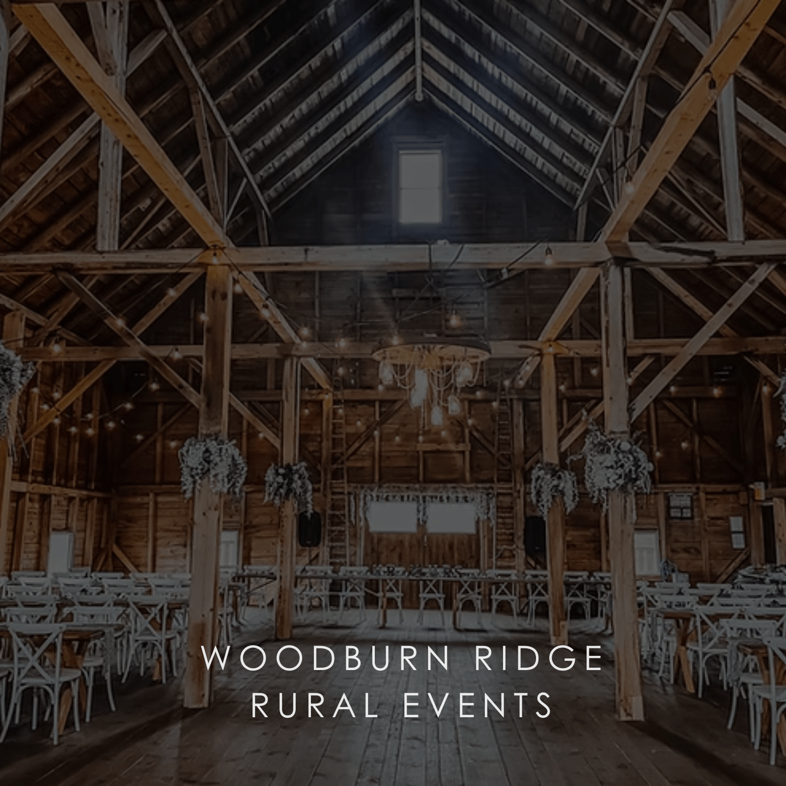 A wide space inside a wooden building set up for a wedding in a photo for Woodburn Ridge Rural Events.