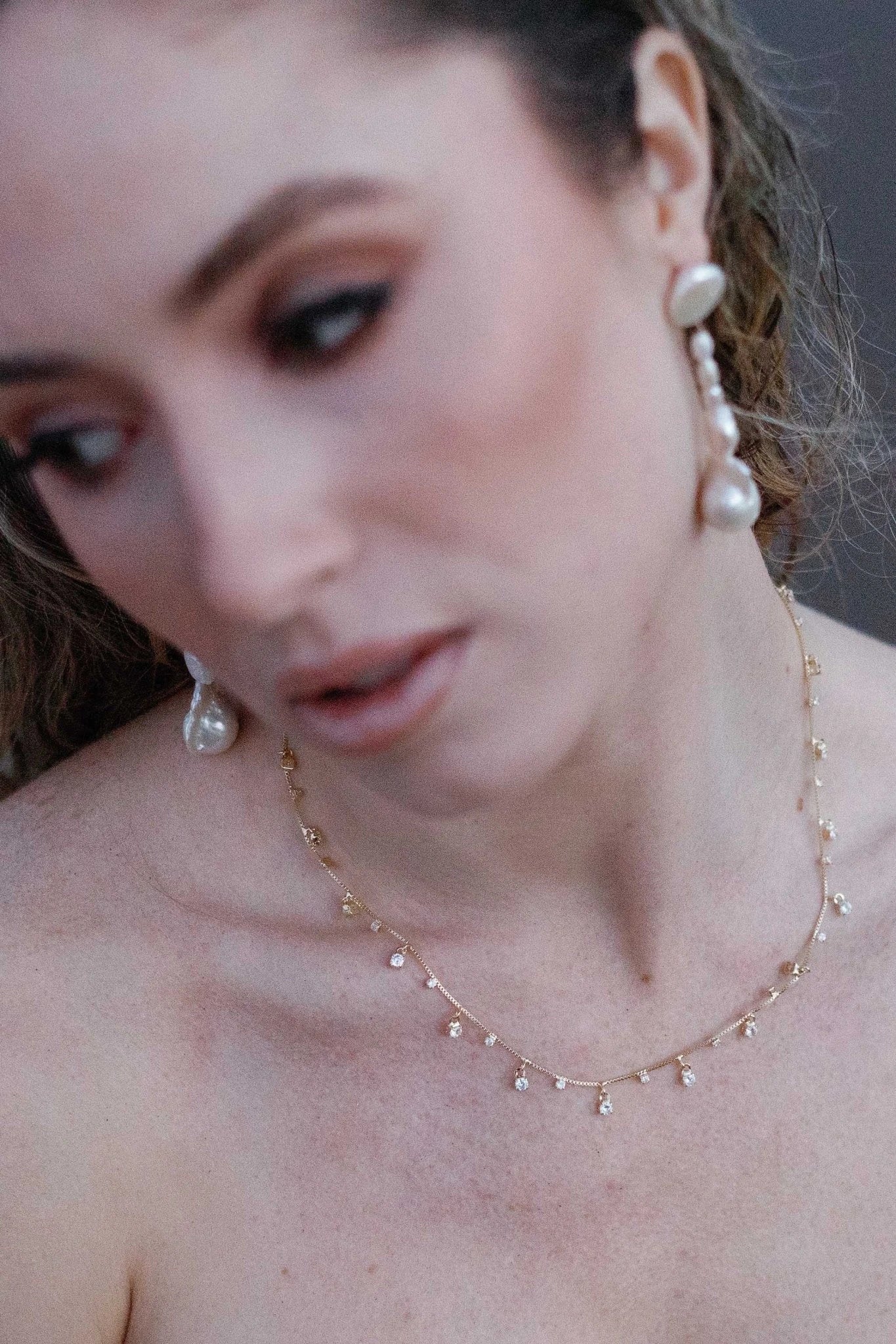 A gorgeous goddess draped with a stardust necklace paired with long dangle freshwater pearl earrings. Statement bridal earrings & freshwater pearl bridal jewelry handmade by a small Canadian jewelry brand
