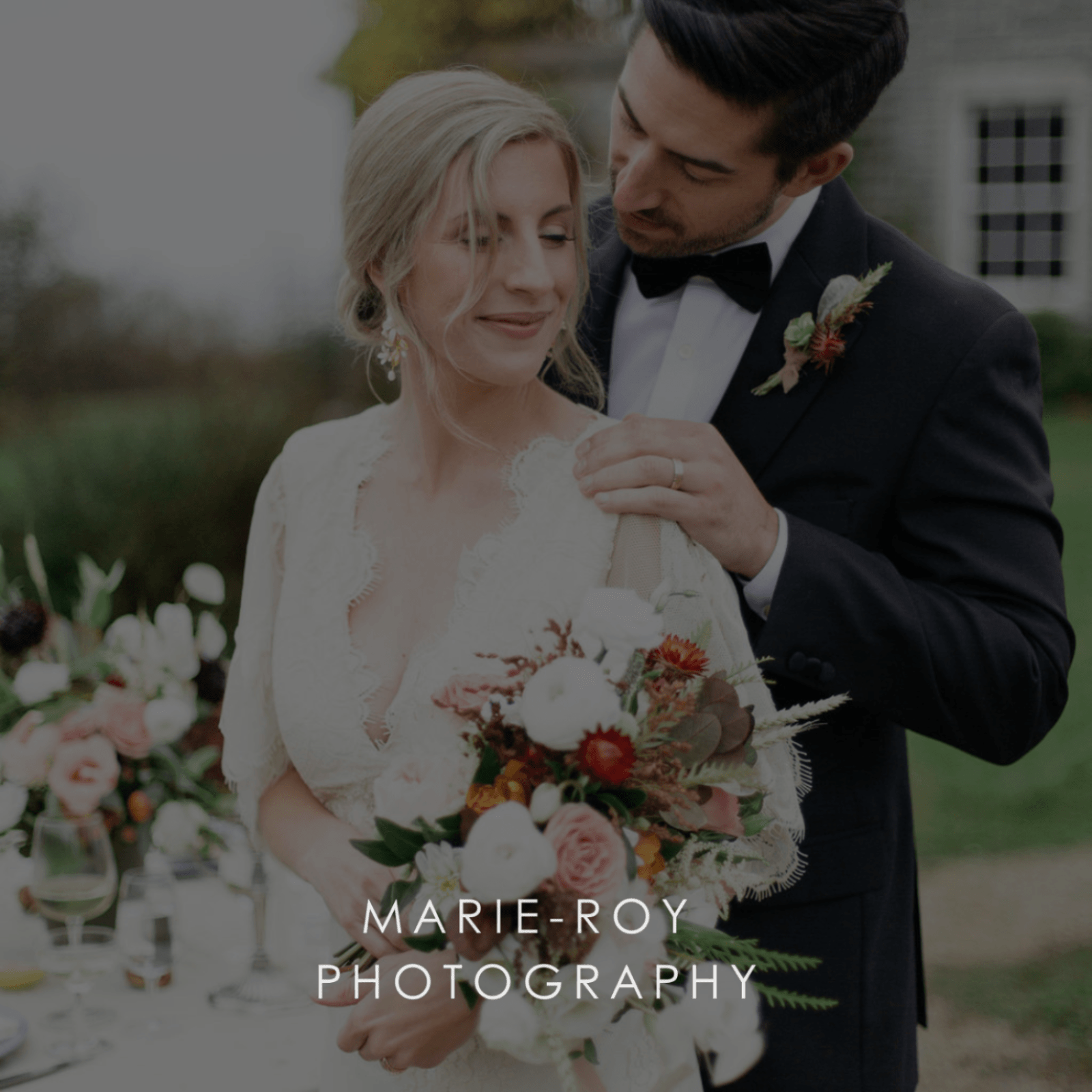 Couple at a wedding with flowers and 'Marie-Roy Photography' text.