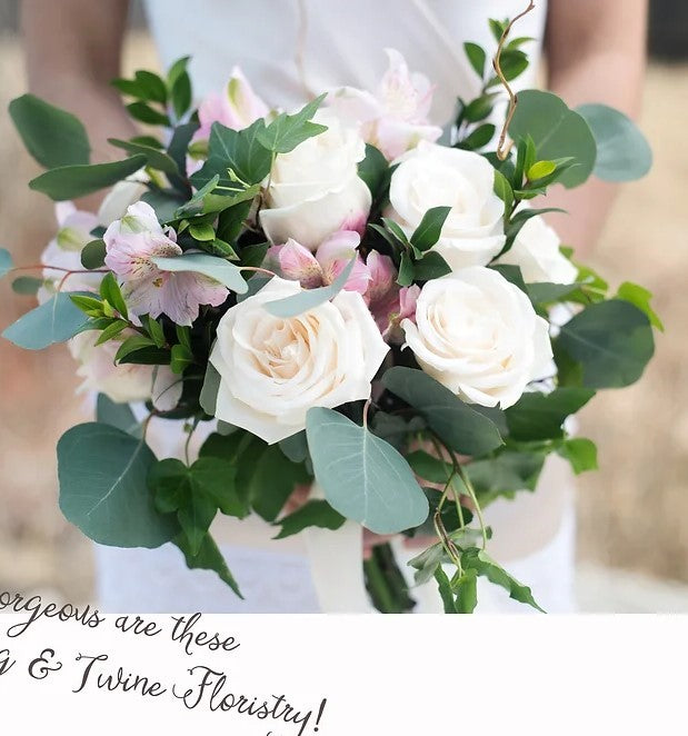 A bouquet of soft pastel roses and leaves.