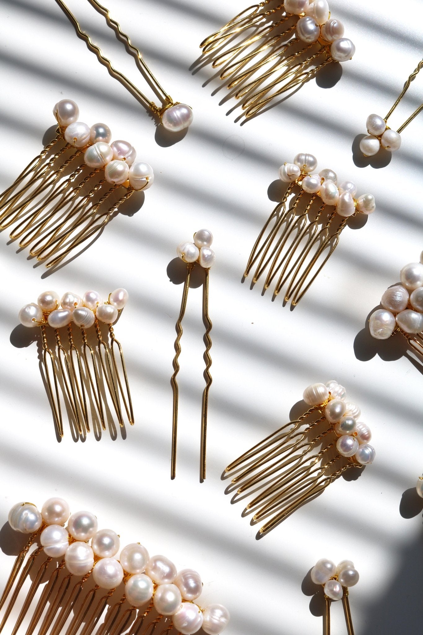 Multiple bridal hair combs and hair pins with all freshwater pearls. 