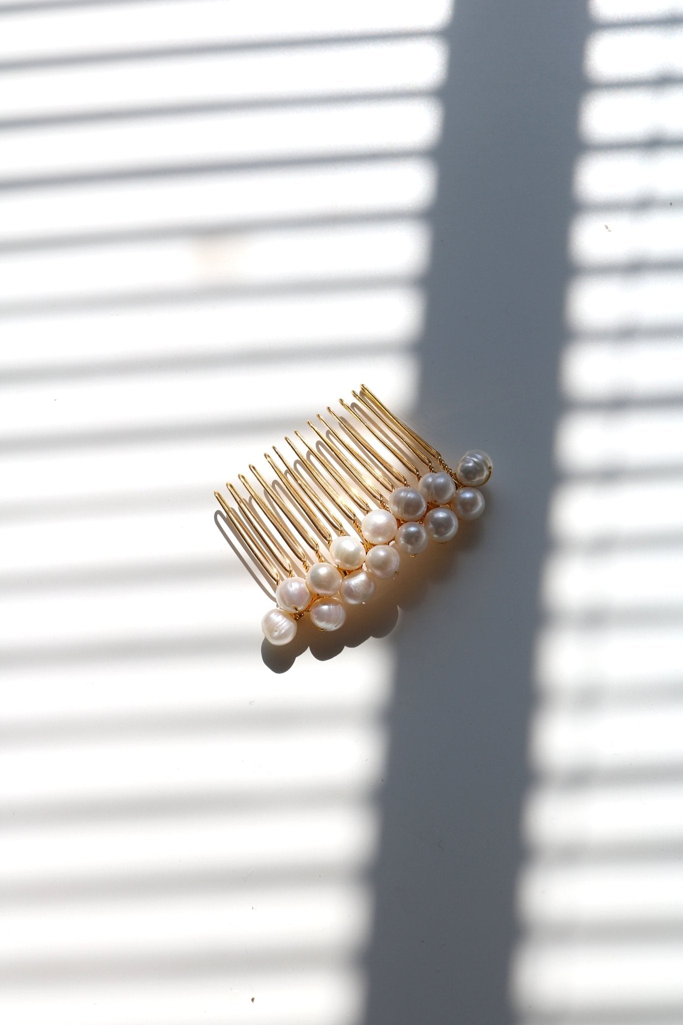 Large golden hair comb with multiple freshwater pearls. 