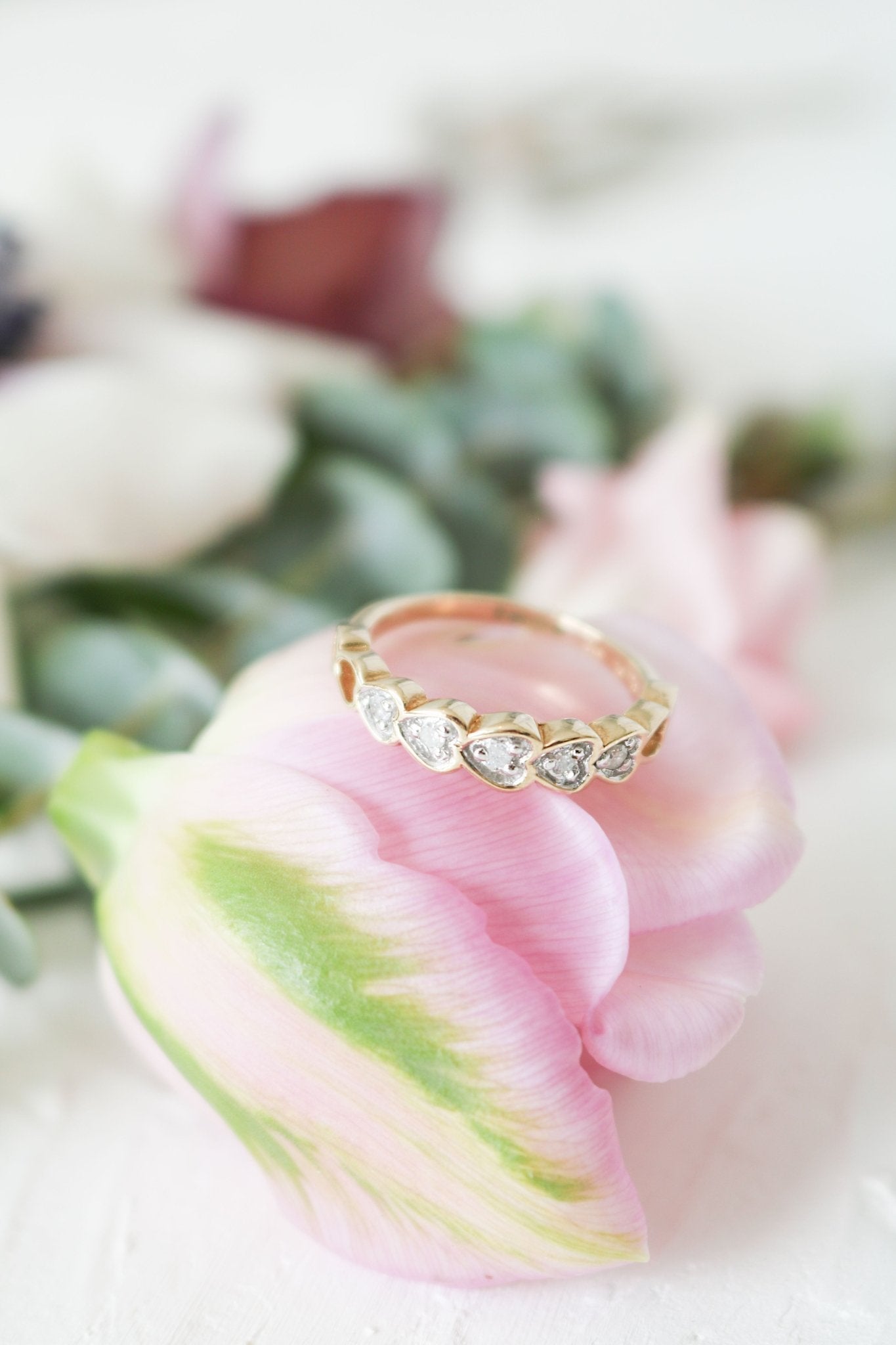 Amore Half Eternity Diamond Heart Wedding Band, Engagement Band in 9ct Gold Atop a Pink Rose.