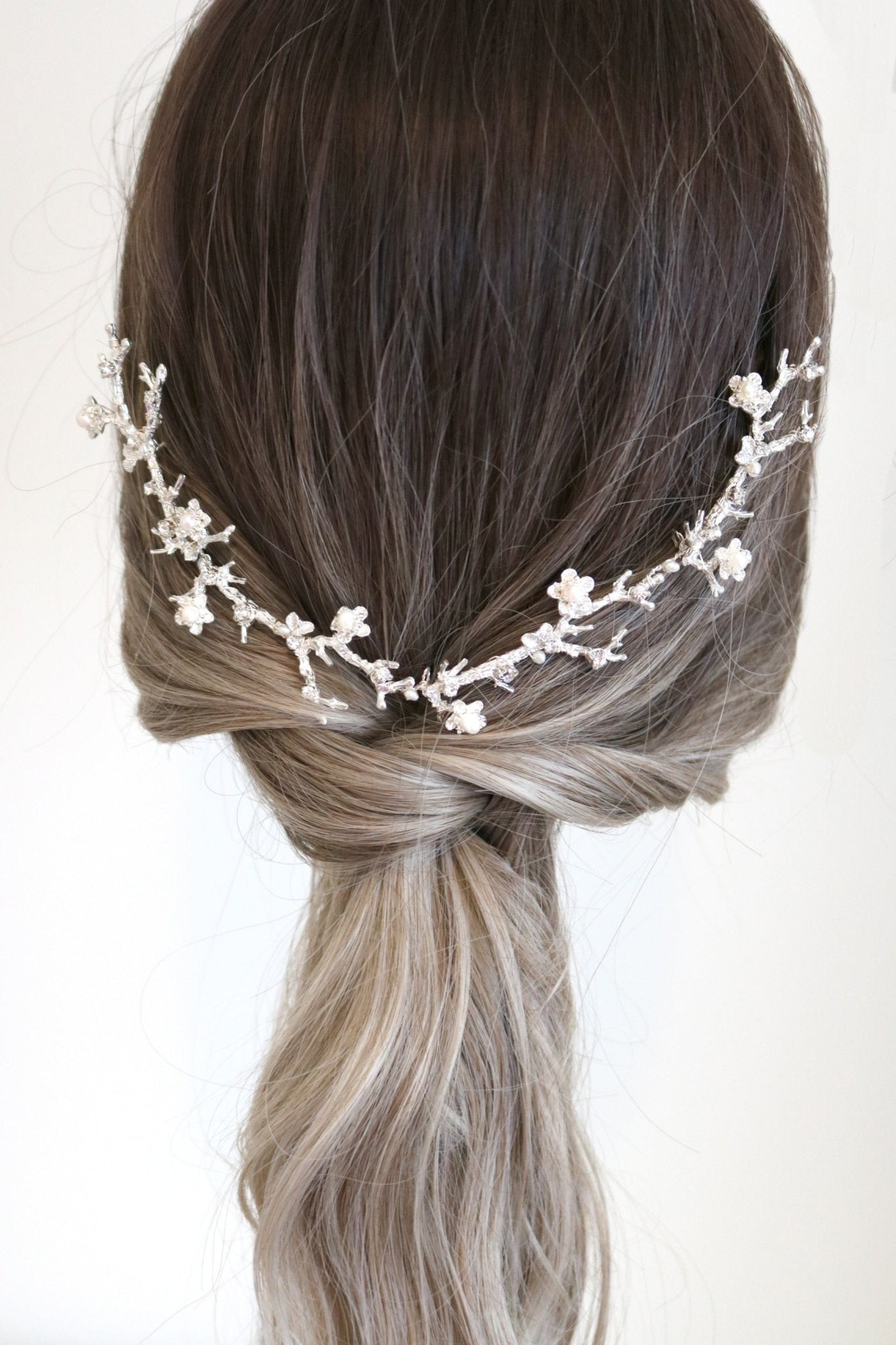 Floral branch hair comb with pearl flowers for bridal jewelry set in ponytail.