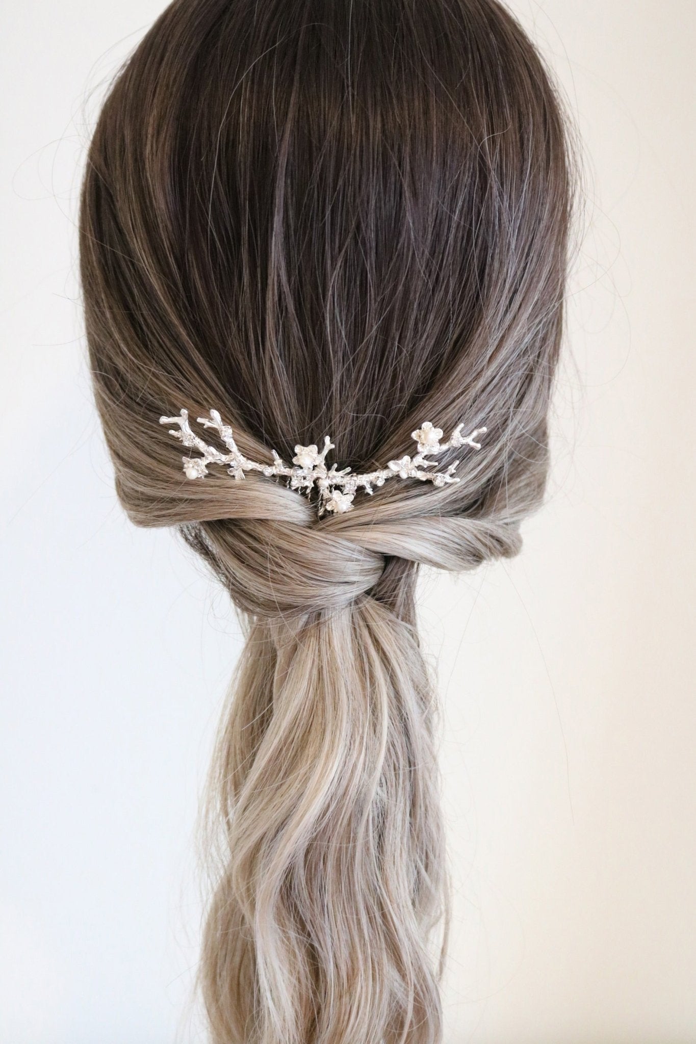 Anthea bridal hair comb for wedding jewelry. Silver floral design set in bridal ponytail. 