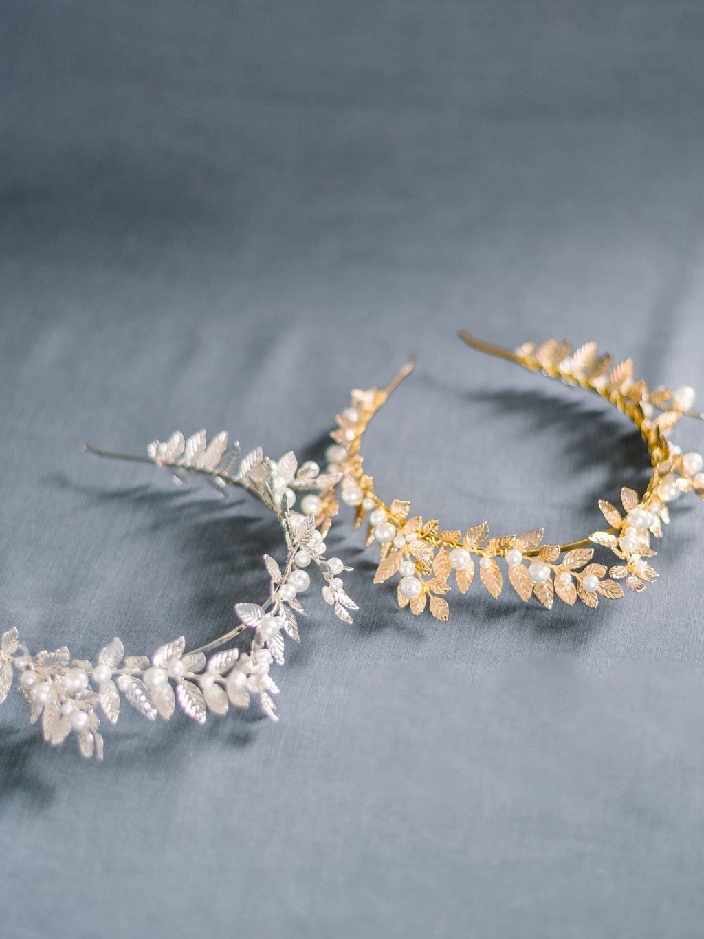 Two freshwater pearl crowns in silver and gold with laurel leaves.