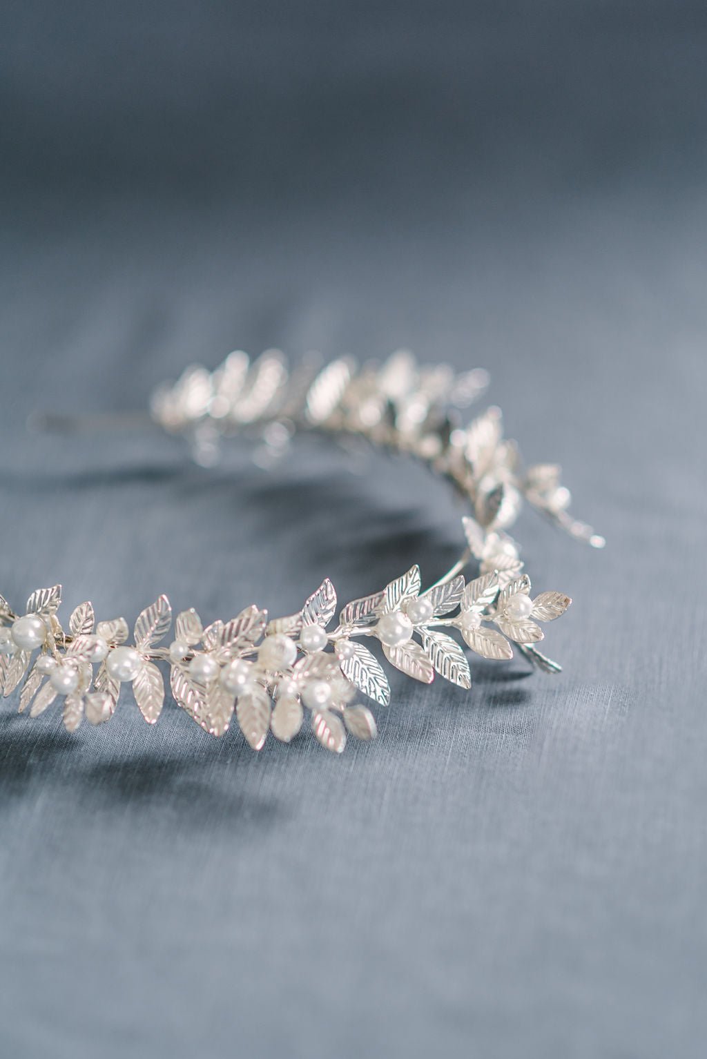 A silver bridal crown with shining leaves and freshwater pearls.