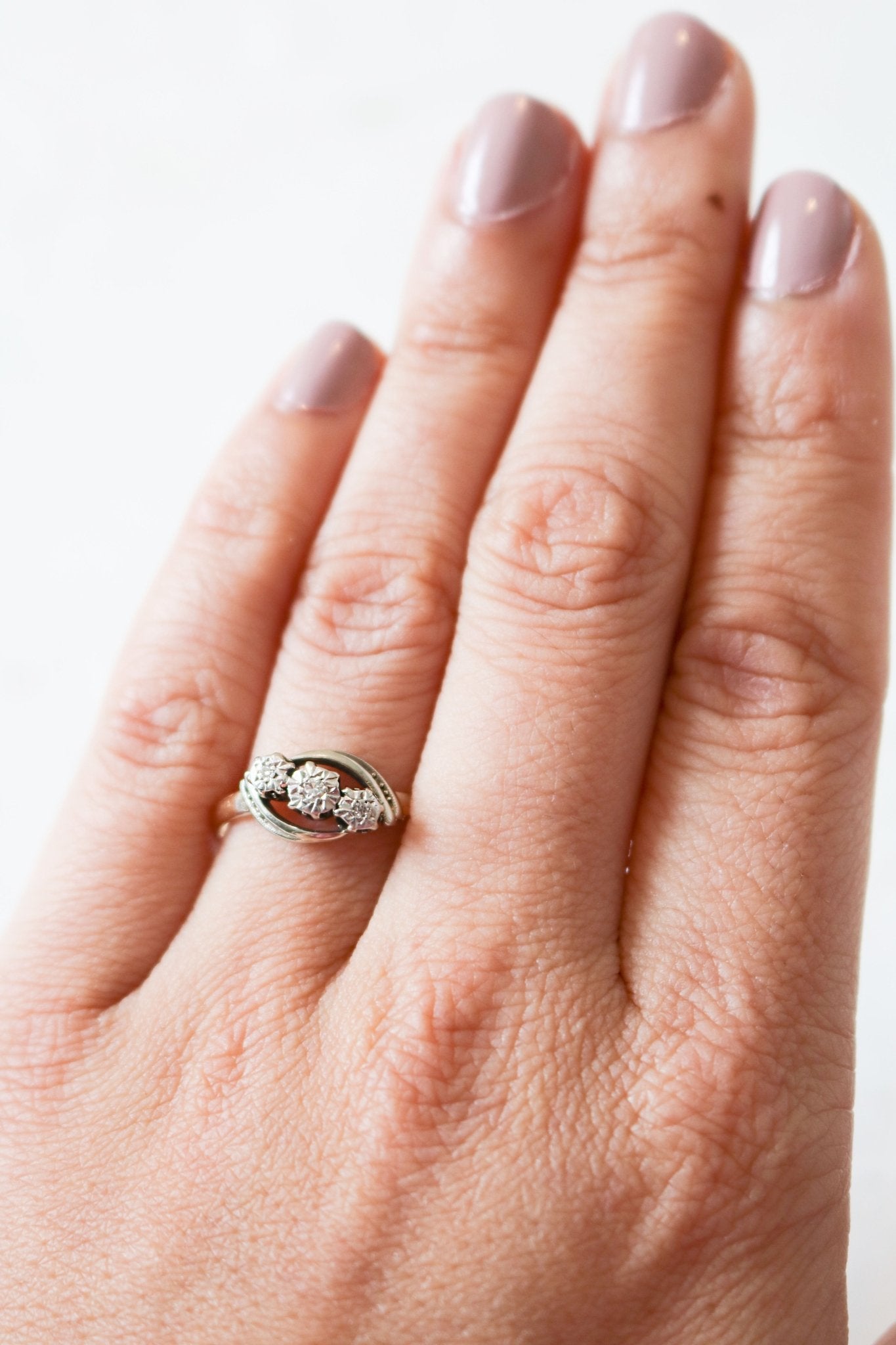 A vintage engagement ring in 18ct gold and platinum with diamonds is worn on a finger. Antique Engagement Rings Canada. Canadian vintage engagement rings. Vintage engagement rings Canada. Bridal jewelry Canada. Canadian jewelry business. Canadian jewelry brands.