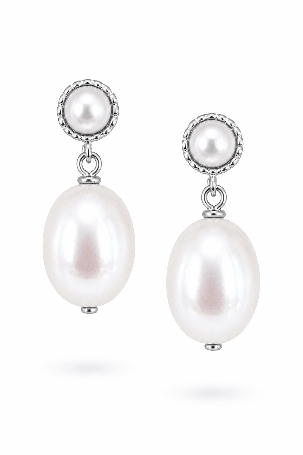 Pair of sterling silver pearl drop earrings on a white background. Handmade pearl earrings by BIPOC Canadian jewellery designer