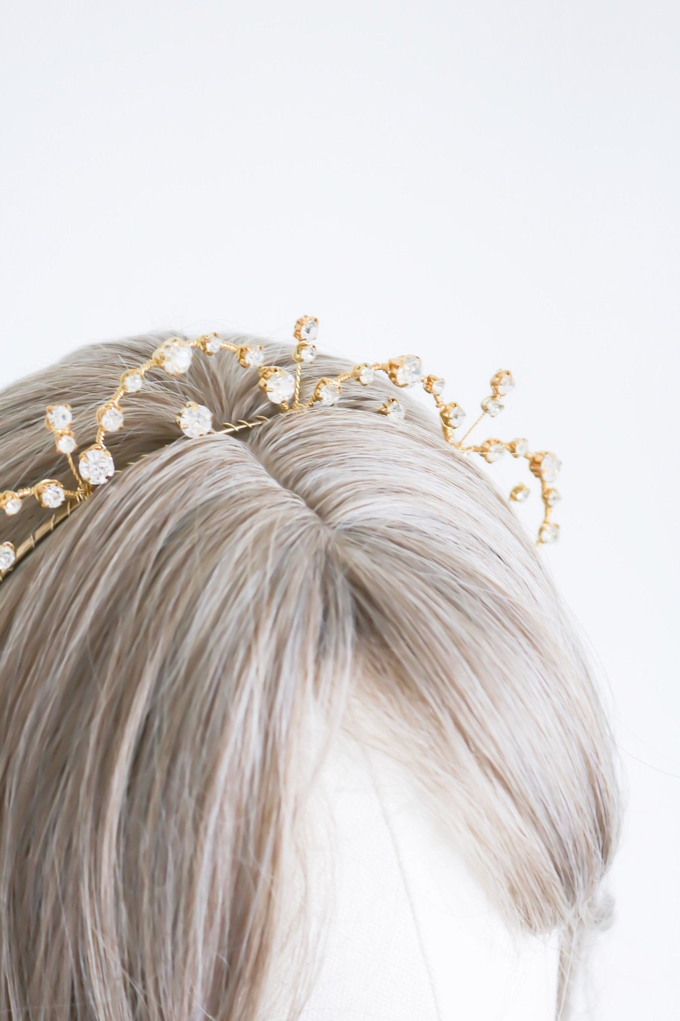 Close up of Gold Avery Crystal Halo Headband on hair of head bust. 