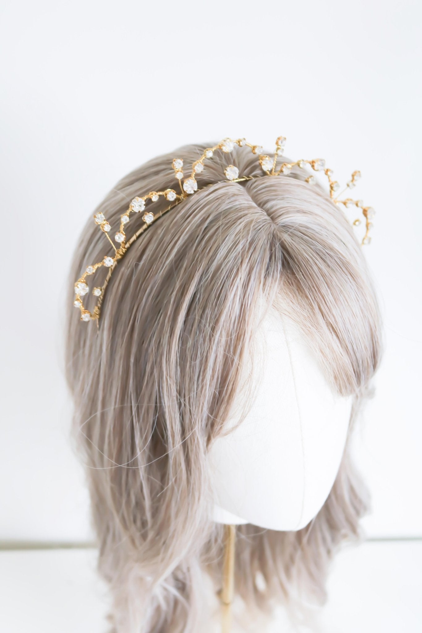 Gold Bridal Crystal Headband sits atop a head bust. Bridal Hair Accessories. Bridal Accessories. Canadian Bridal Accessories. Handmade Canadian Accessories. Canadian handmade Accessories. Canadian weddings. Wedding Canada. Canadian designer. Canadian artist.