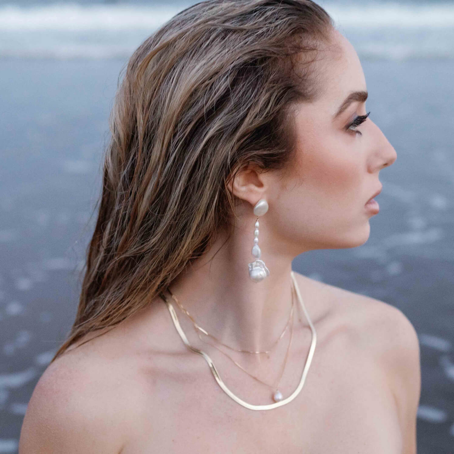 A seaside goddess with stacked gold-filled necklaces and freshwater pearl dangle earrings. Pearl Bridal jewelry, everyday jewelry, & Gold-filled Canadian jewelry handmade by Canadian jewelry designer