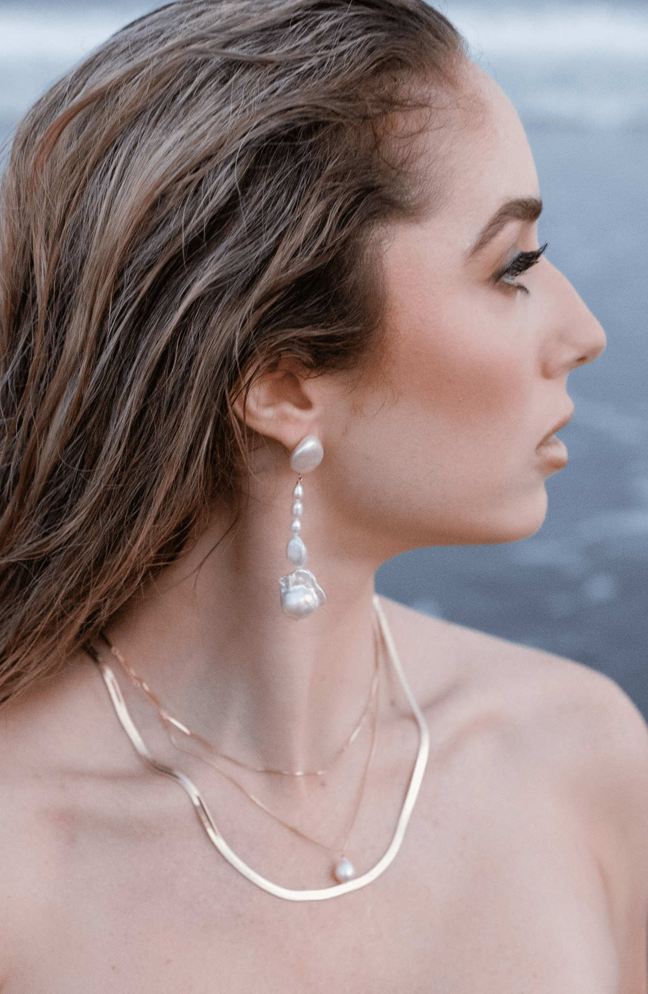 A seaside goddess with stacked gold-filled necklaces and freshwater pearl dangle earrings. Pearl Bridal jewelry Canada. Canadian jewelry brands. Canadian jewelry business 
Organic pearl jewelry. Pearl jewelry sets. Statement Earrings. Statement Bridal Earrings.