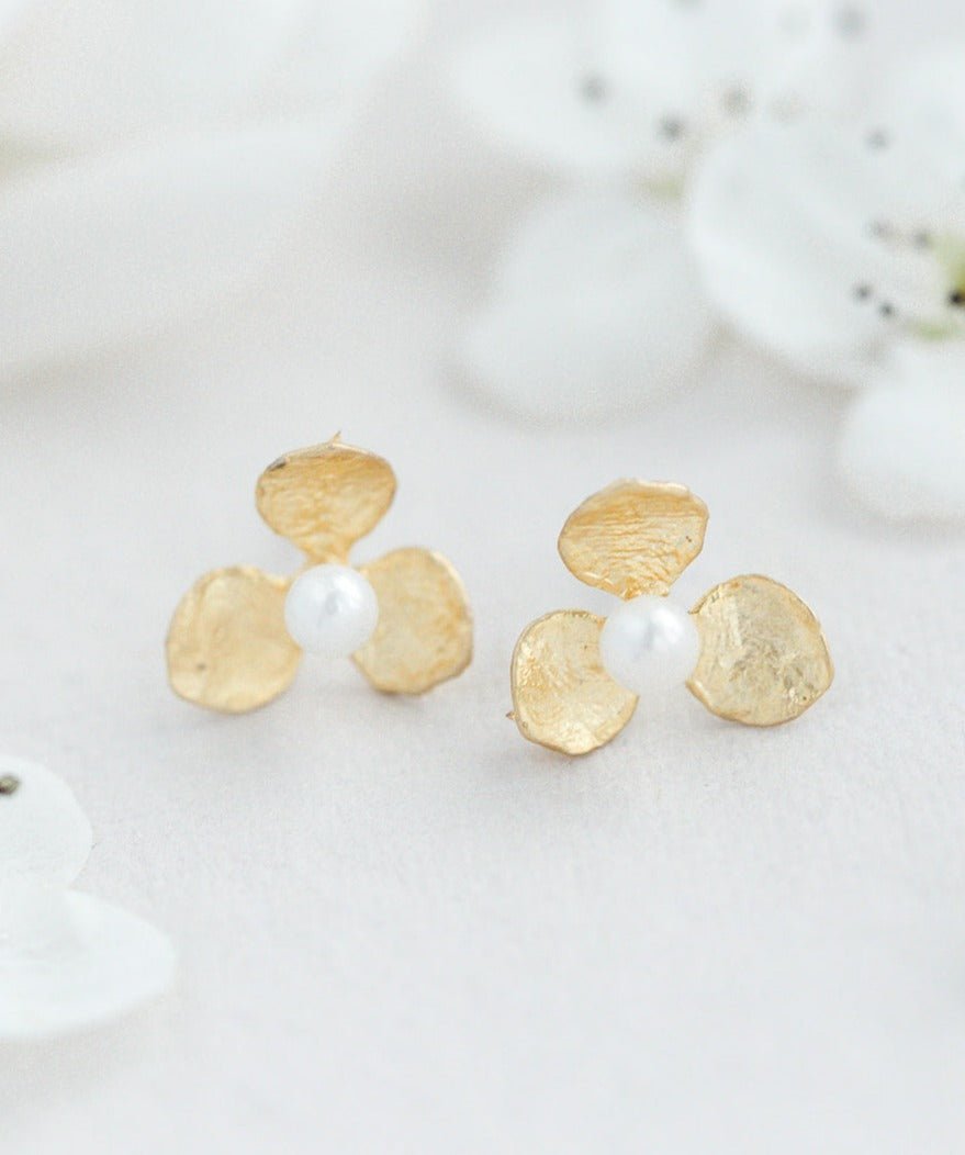 Gold-filled flower & freshwater pearl studs with freshwater pearls & sterling silver posts on white background. Gold-filled Canadian jewelry & pearl earrings handmade by an affordable Canadian jewelry brand