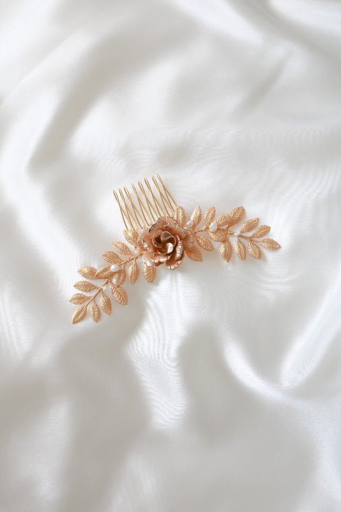 Inverted elegant Belle Floral hair comb with Fresh Water Pearls laying on a white satin fabric. Bridal Hair Accessories. Bridal Accessories. Canadian Bridal Accessories. Handmade Canadian Accessories. Canadian handmade Accessories. Canadian weddings. Wedding Canada. Organic pearl accessories. Pearl Bridal Hair Accessories. Pearl Bridal Accessories. Small Canadian jewelry brands.