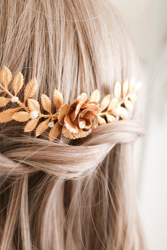 Gold leaf and rose hair accessory on blonde hair against a neutral background. Bridal hair accessories
& bridal hair combs handmade by affordable Canadian jewelry brand