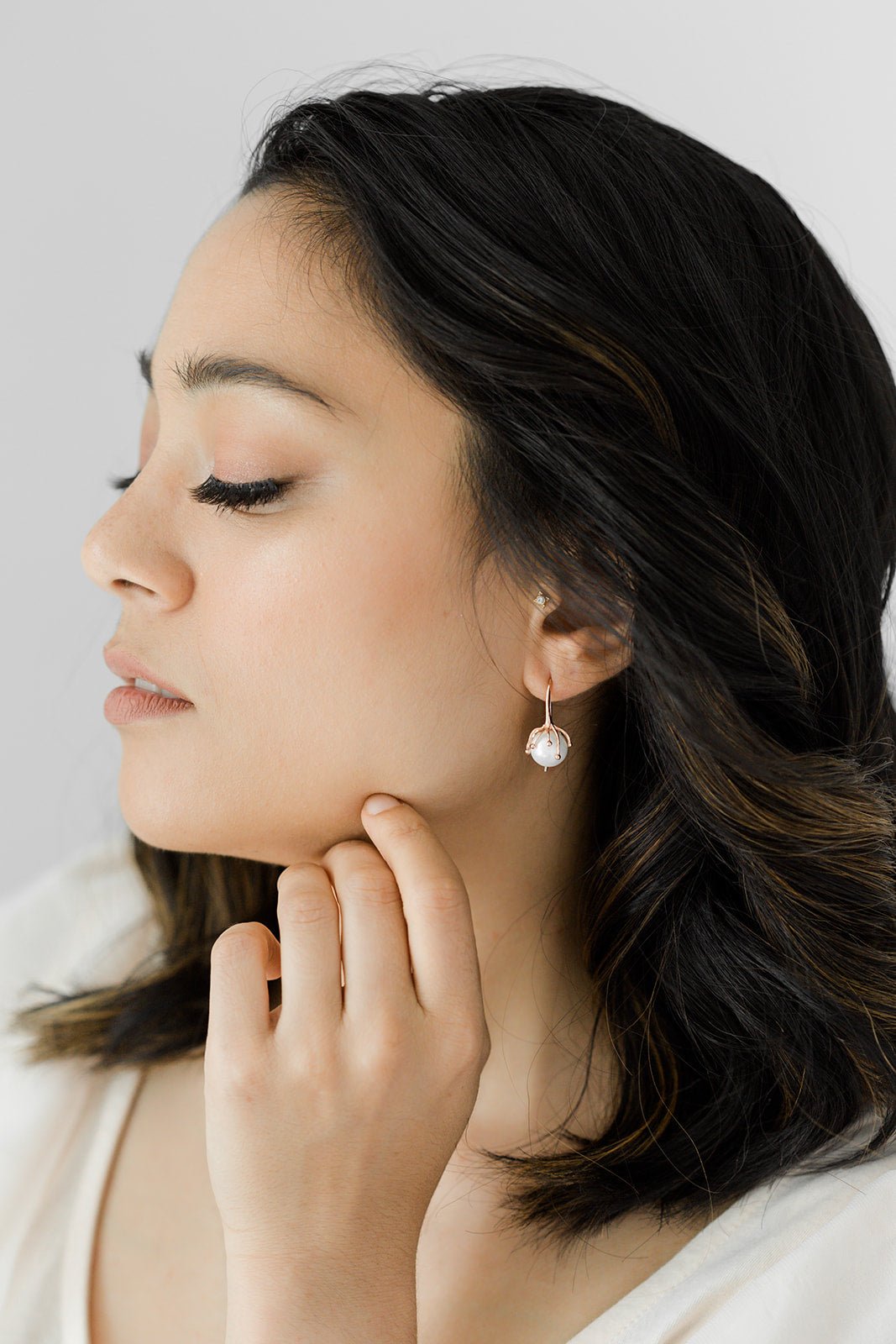 A woman wearing the Bloom Flower Bud and Freshwater Pearl Bridal Earrings. Bridal jewelry Canada. 
Pearl jewelry Canada. Pearl Bridal jewelry Canada. Gold-filled jewelry Canada. Organic Pearl jewelry. Woman-owned Canadian jewelry brand. Canadian jewelry business. 