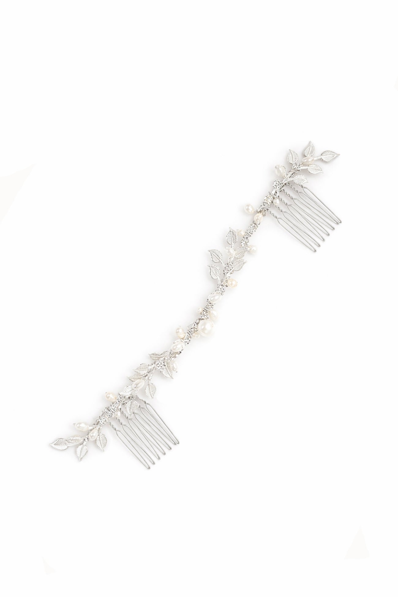 A silver hairvine with freshwater pearls and crystals is delicately placed above a bridal bun. Bridal Hair Accessories. Bridal Accessories. Canadian Bridal Accessories. Handmade Canadian Accessories. Canadian handmade Accessories. Canadian weddings. Wedding Canada. Organic pearl accessories. Pearl Bridal Hair Accessories. Pearl Bridal Accessories.