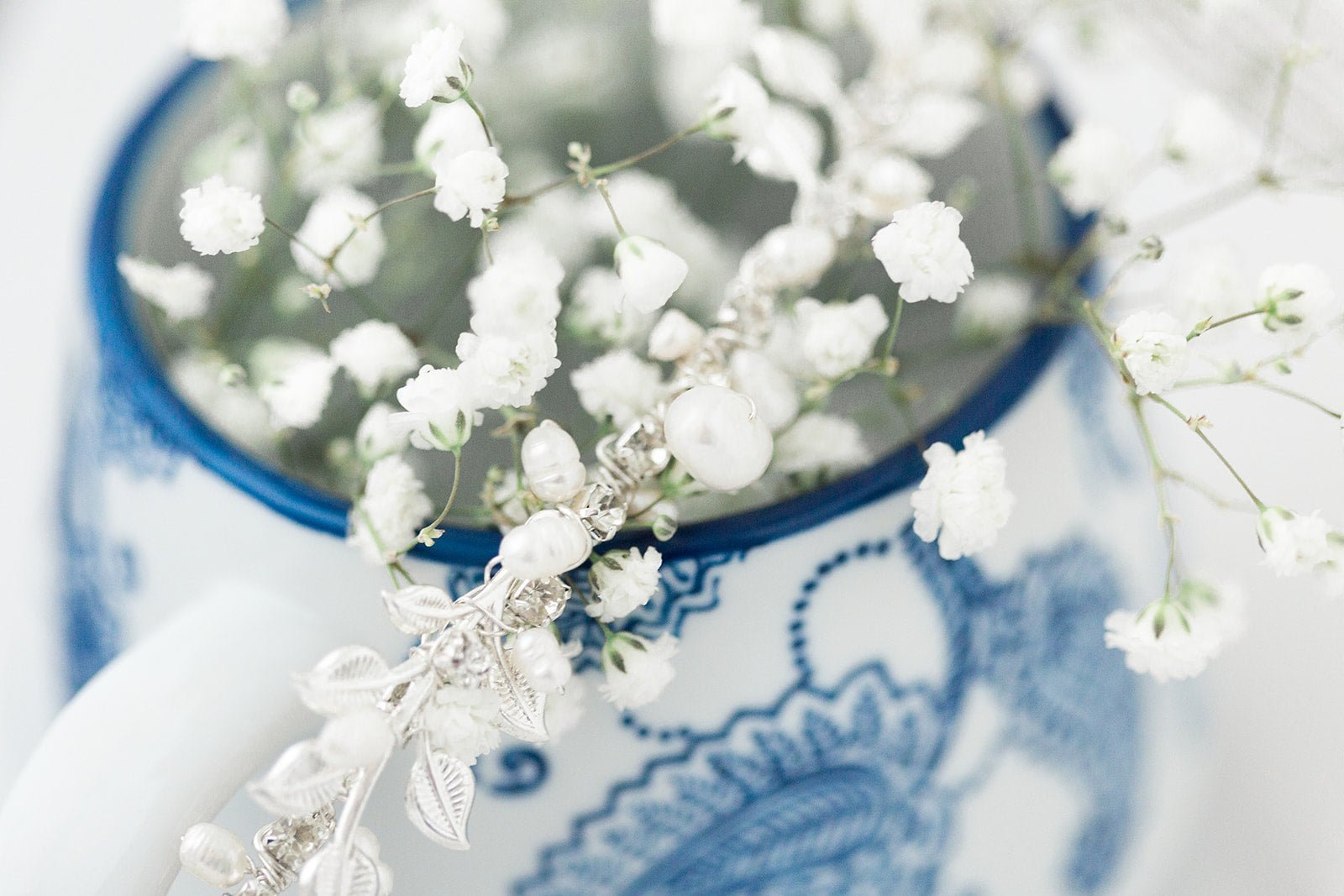 Silver bridal hair accessory with Swarovski crystals & freshwater pearls nestled in baby's breath flowers sitting in a flower vase. Affordable bridal accessories, organic pearl accessories, & Canadian bridal accessories handmade by small Canadian jewelry brand
