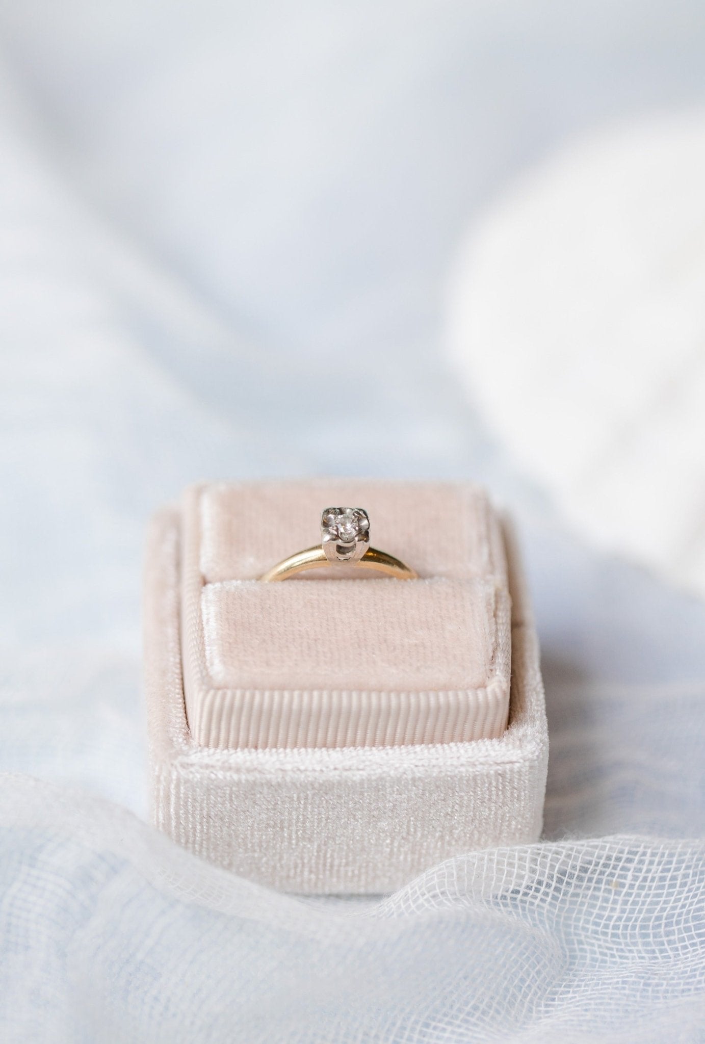 A 14k Yellow and White Gold Vintage Diamond Engagement Ring sits in a ring box. 