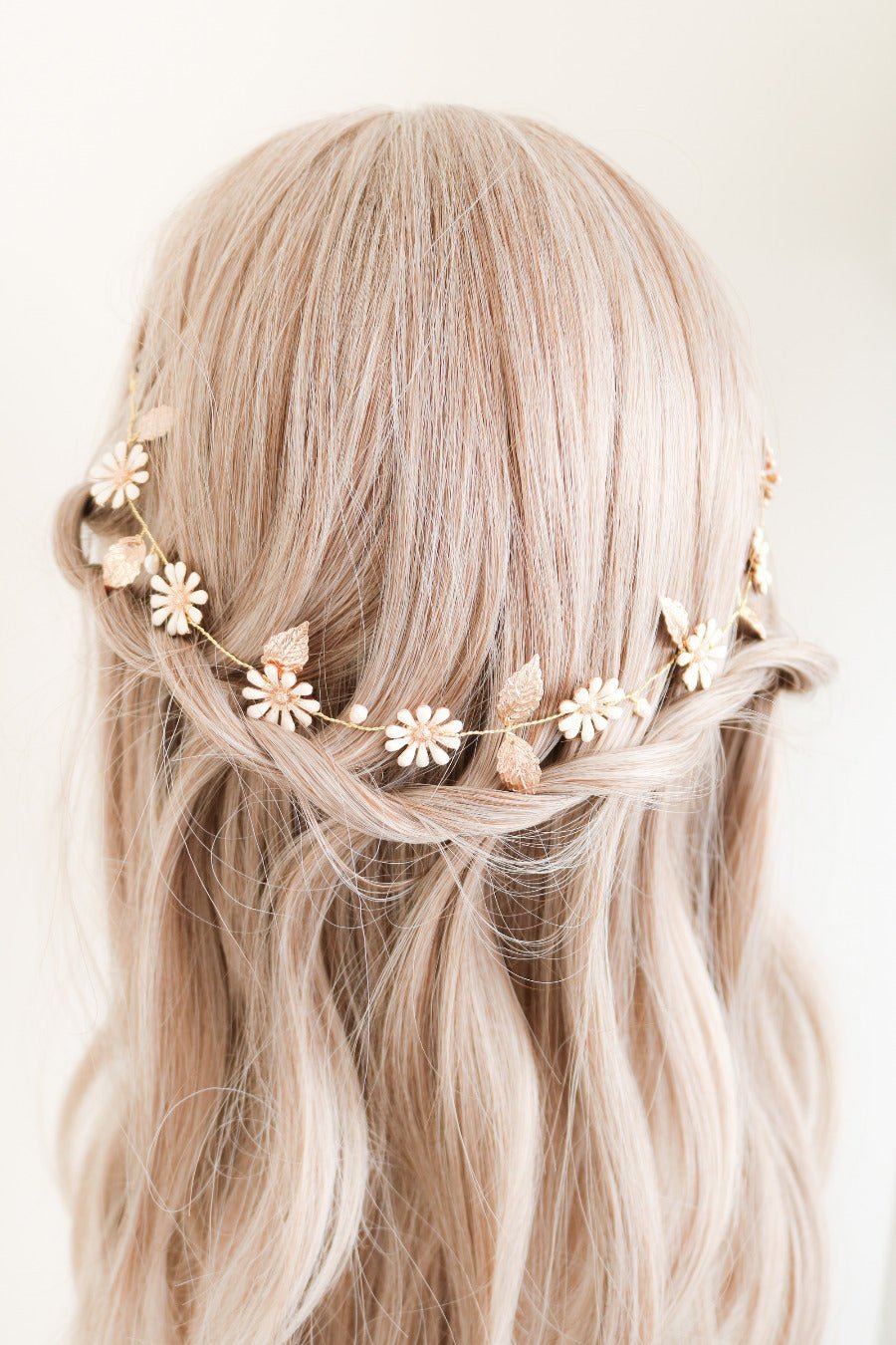 A Daisy Chain Hairvine with Fresh Water Pearls elegantly woven above a bridal hairdo. 