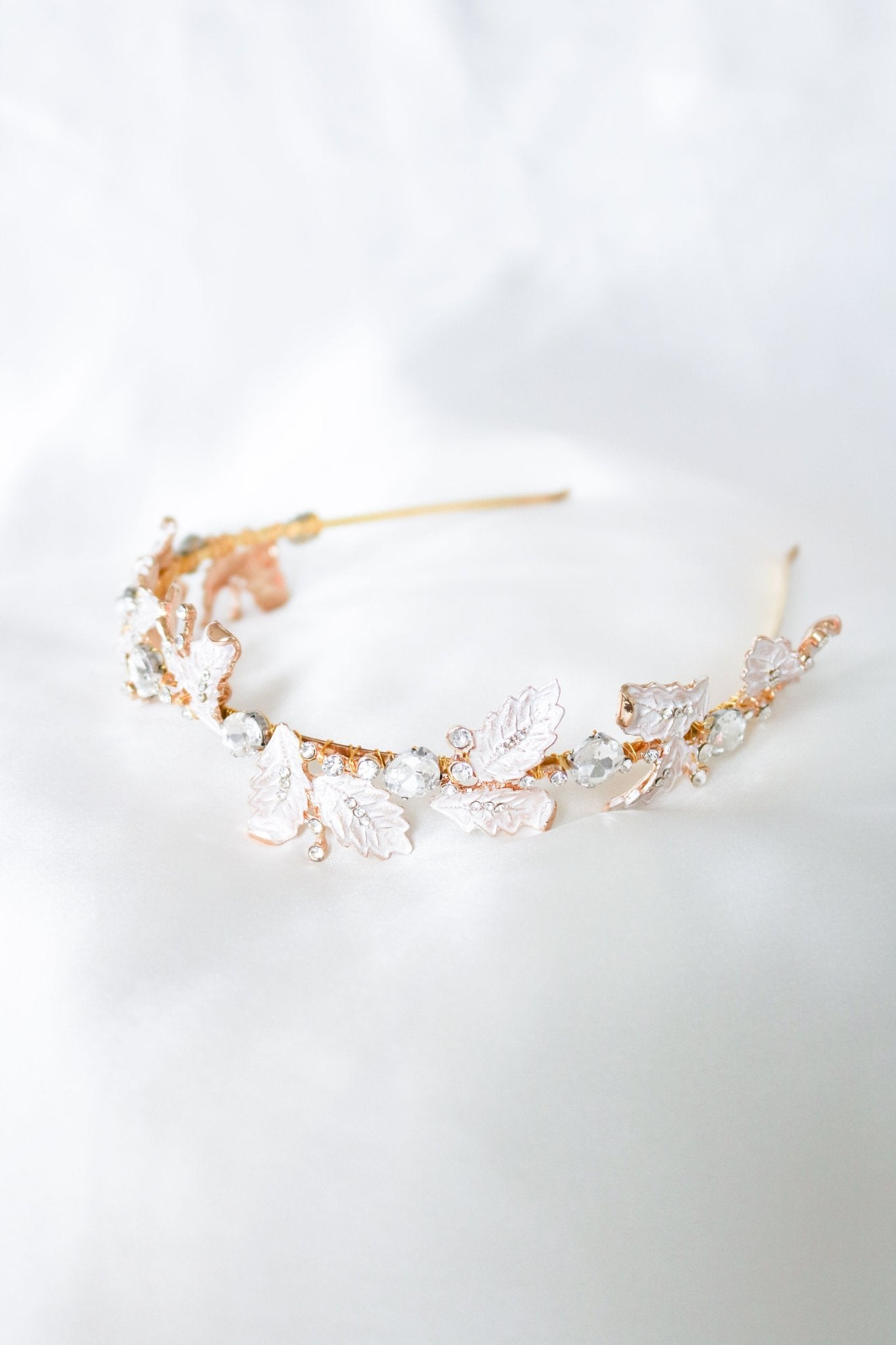 Detailed gold bridal headband with leaves and crystals.