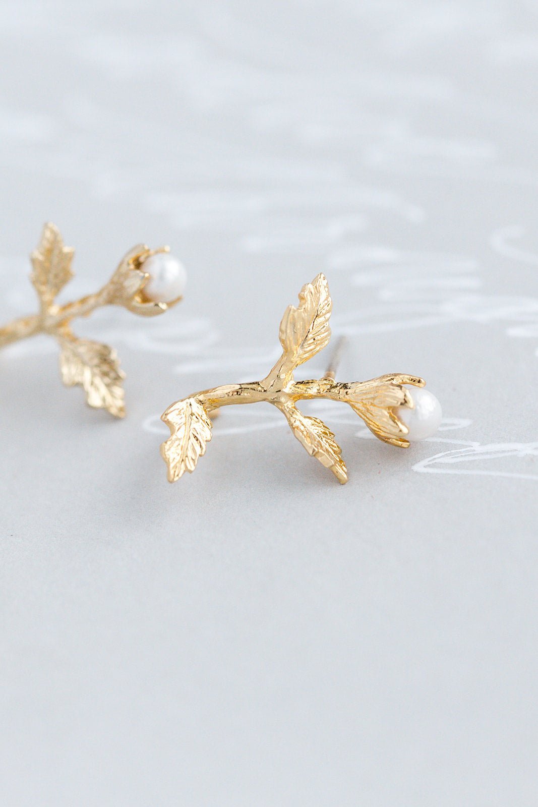 A pair of Gold-filled freshwater pearl & flower stud earrings. Pearl Bridal jewelry, Gold-filled jewelry & Canadian handmade jewelry by Woman-owned Canadian jewelry brand