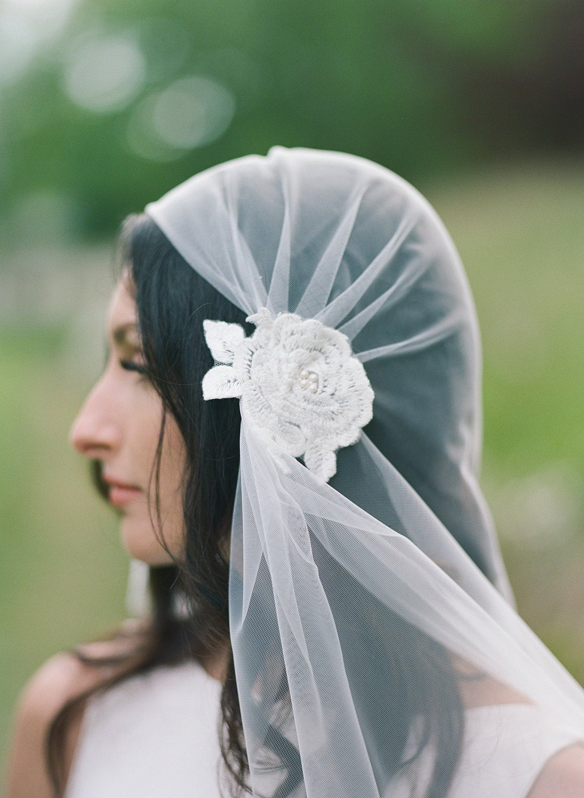 A close up of a bride wearing the Desert Rose Juliet Cap Bridal Veil.