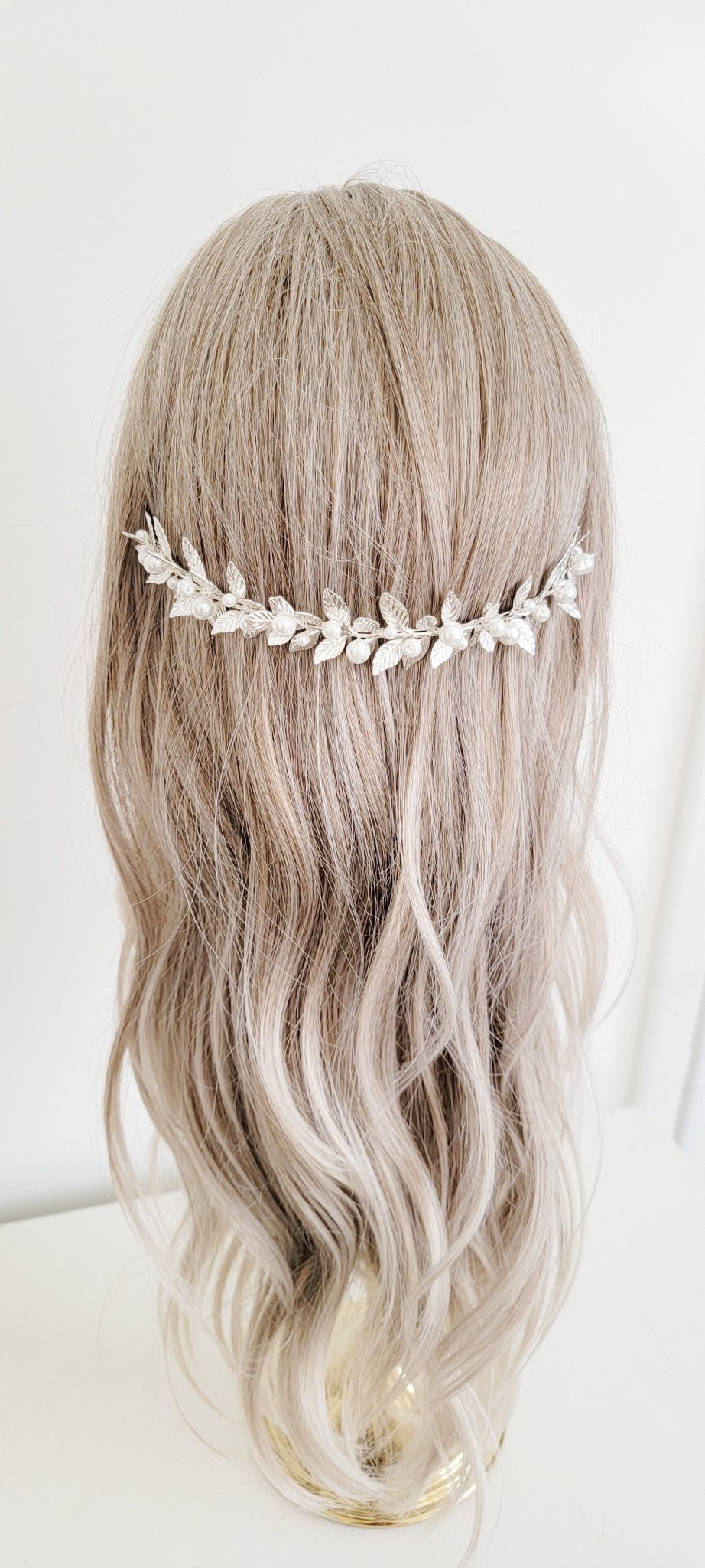 Bridal headband with full silver laurel leaves and freshwater pearls worn behind the head. 