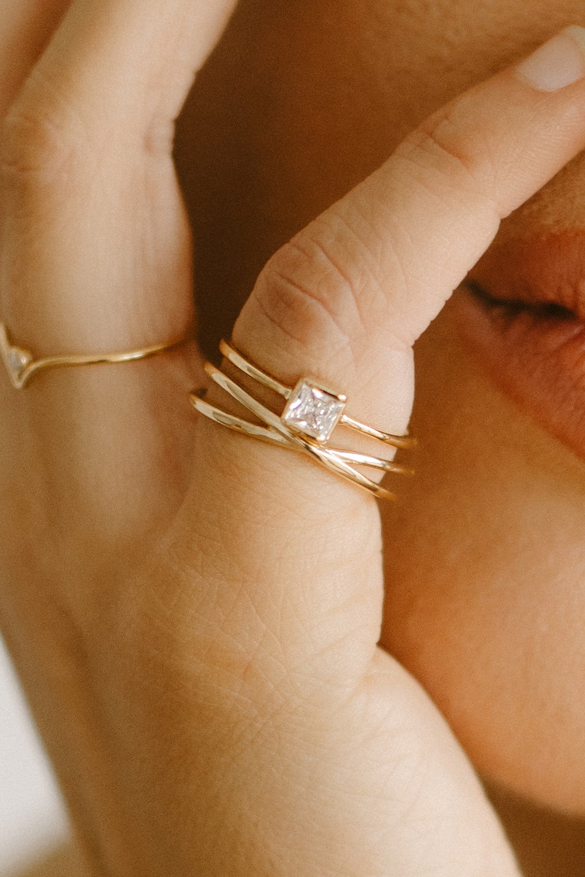 Close-up of a hand wearing two gold-filled rings with crystal accent. Canadian jewelry brands. Minimalist Jewelry. Canadian jewelry designs.
