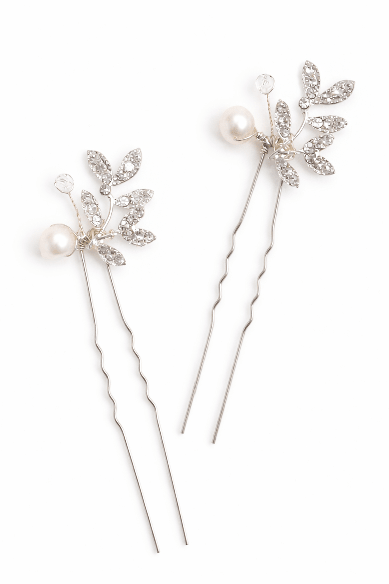Two decorative bridal hairpins with fresh water pearls and crystals in a leaf design on a white background. Handmade bridal accessories & bridal hair accessories by Canadian jewelry artist