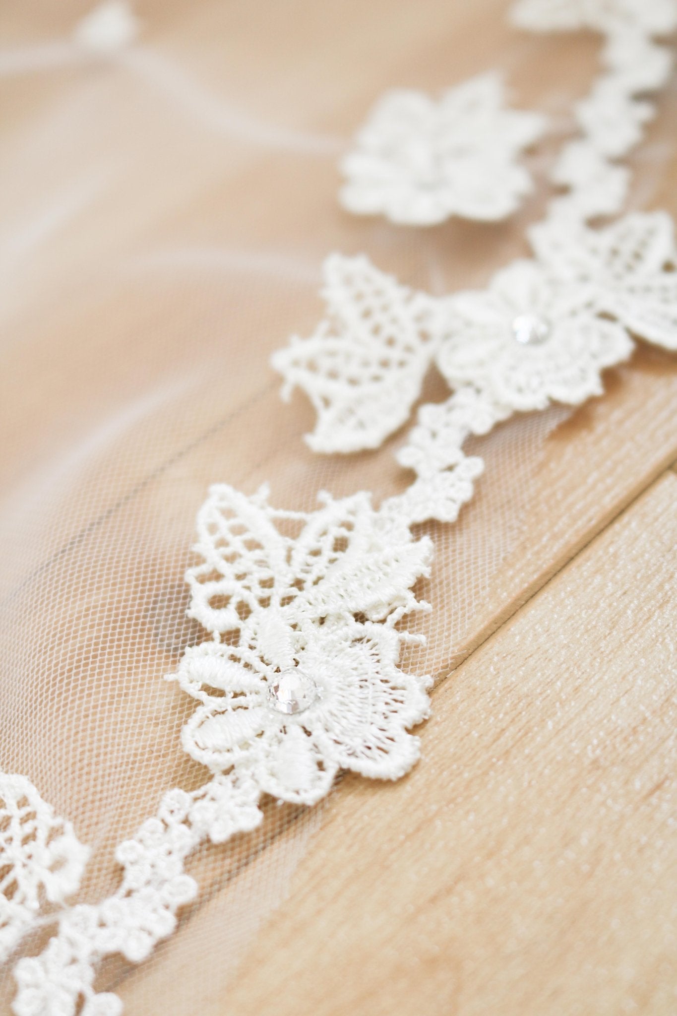 A close up of the detailed embroidered flowers on a wedding veil. 