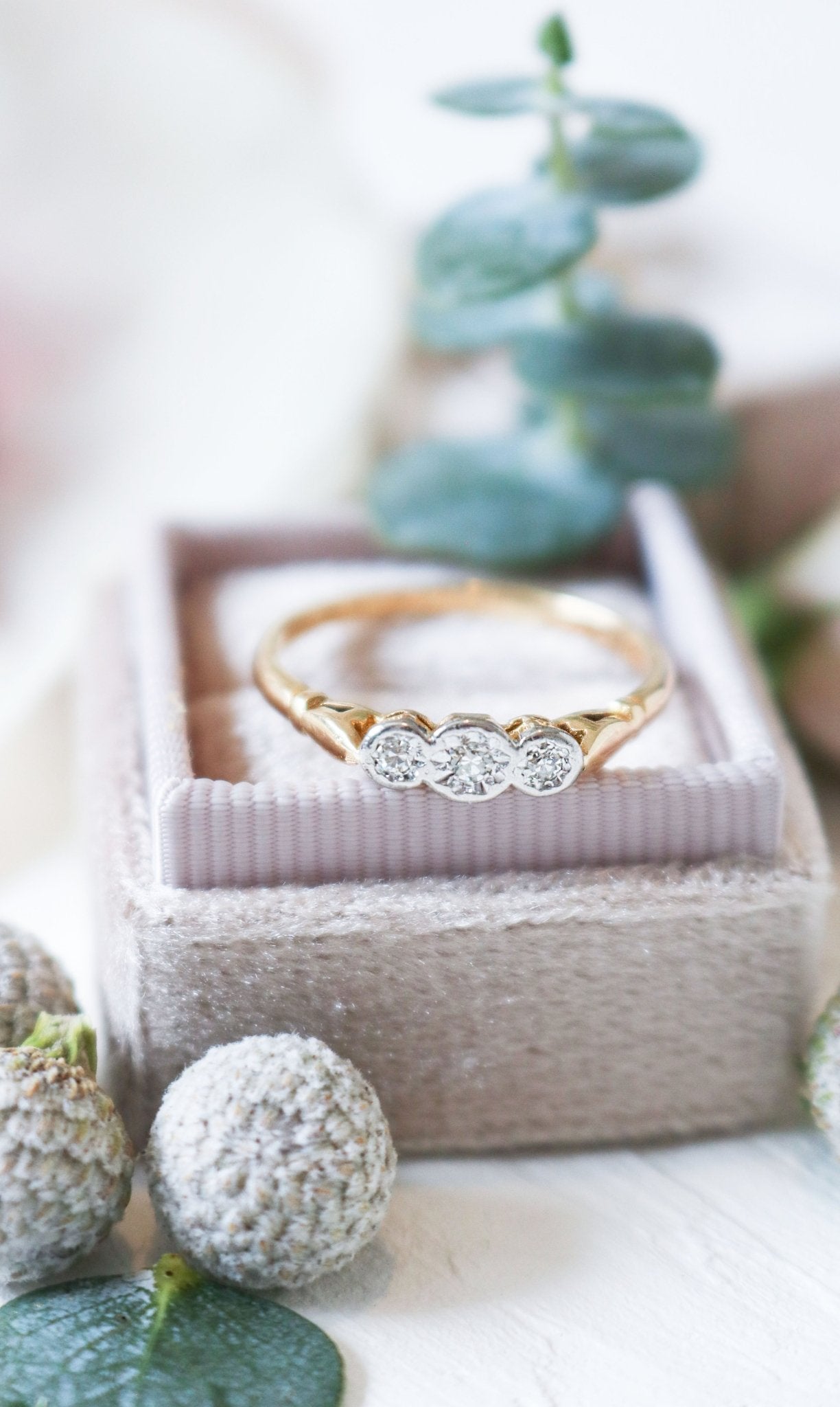 Gold, Platinum, and Diamond Vintage Engagement Ring sits on top of a ring box. 