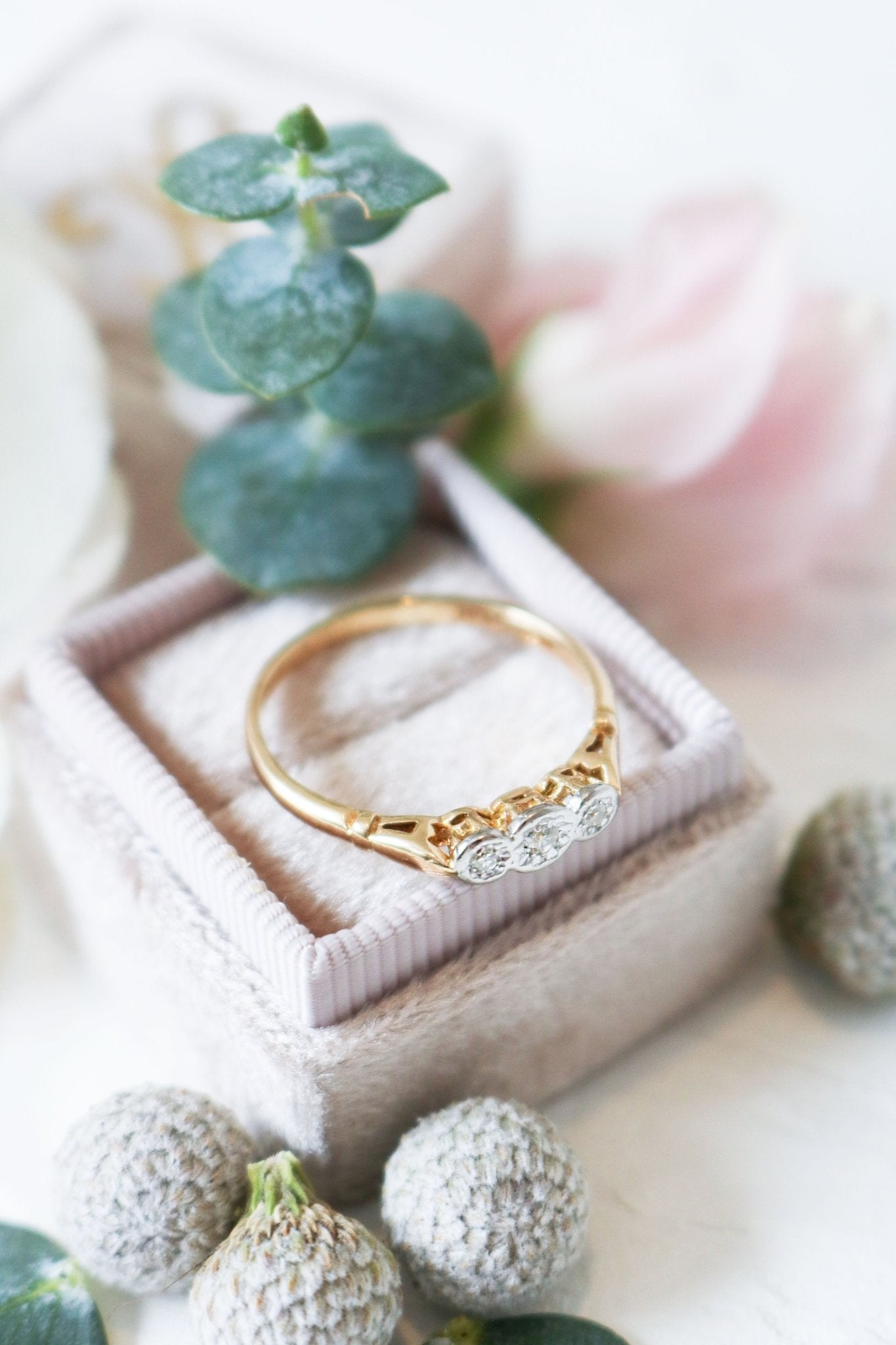 Gold, Platinum, and Diamond Vintage Engagement Ring sits on top of a ring box. 